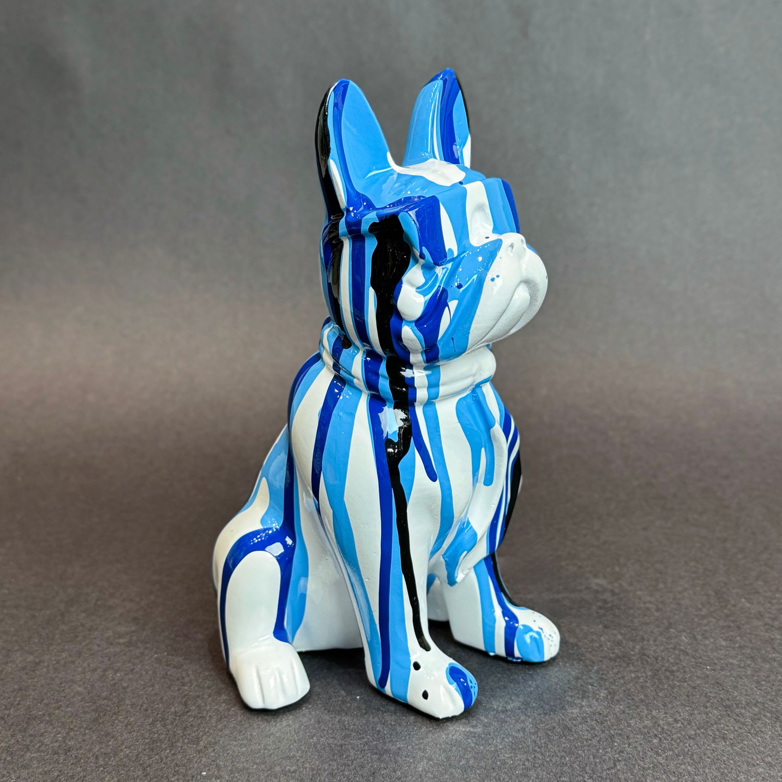 8 inch Blue Paint Drip French Bull Dog with Sunglasses: Graffiti Drip French Bulldog Sculpture Medium: Resin Size: 5 w x 8 h x 4 d Weight: 1.5lbs. This a playful and vibrant dog sculpture that blends graffiti art influences with the charm of the iconic Fre
