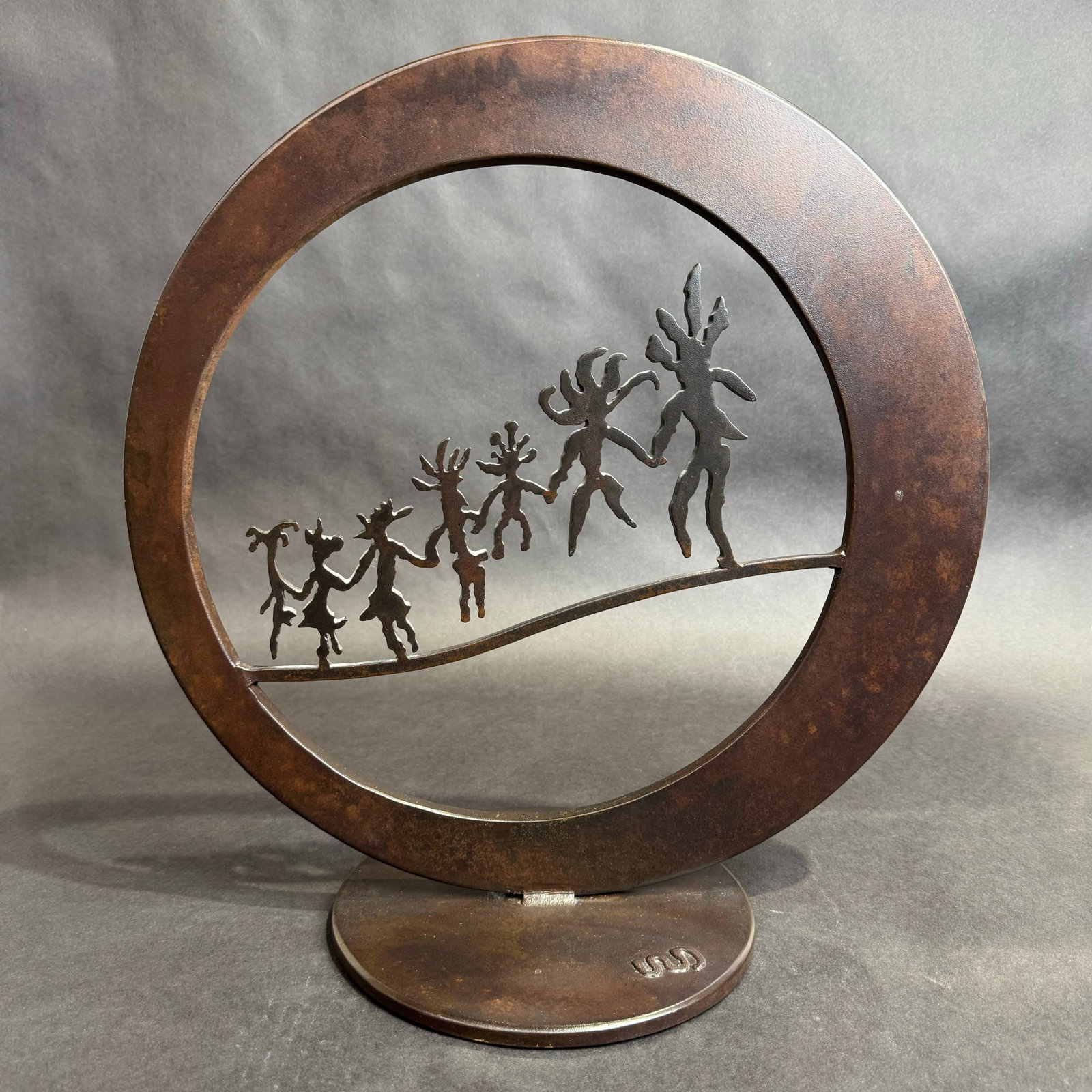 Doug Weigle 15.5x15.75 Petroglyph Steel Sculpture: Artist: Doug Weigle Title: Petroglyph Circle Medium: Patina Steel Size: 15.5 w x 15.75 h x Signature: Artist mark welded on bottom of base Production Year: 2000 Condition: Sculpture is in good conditi