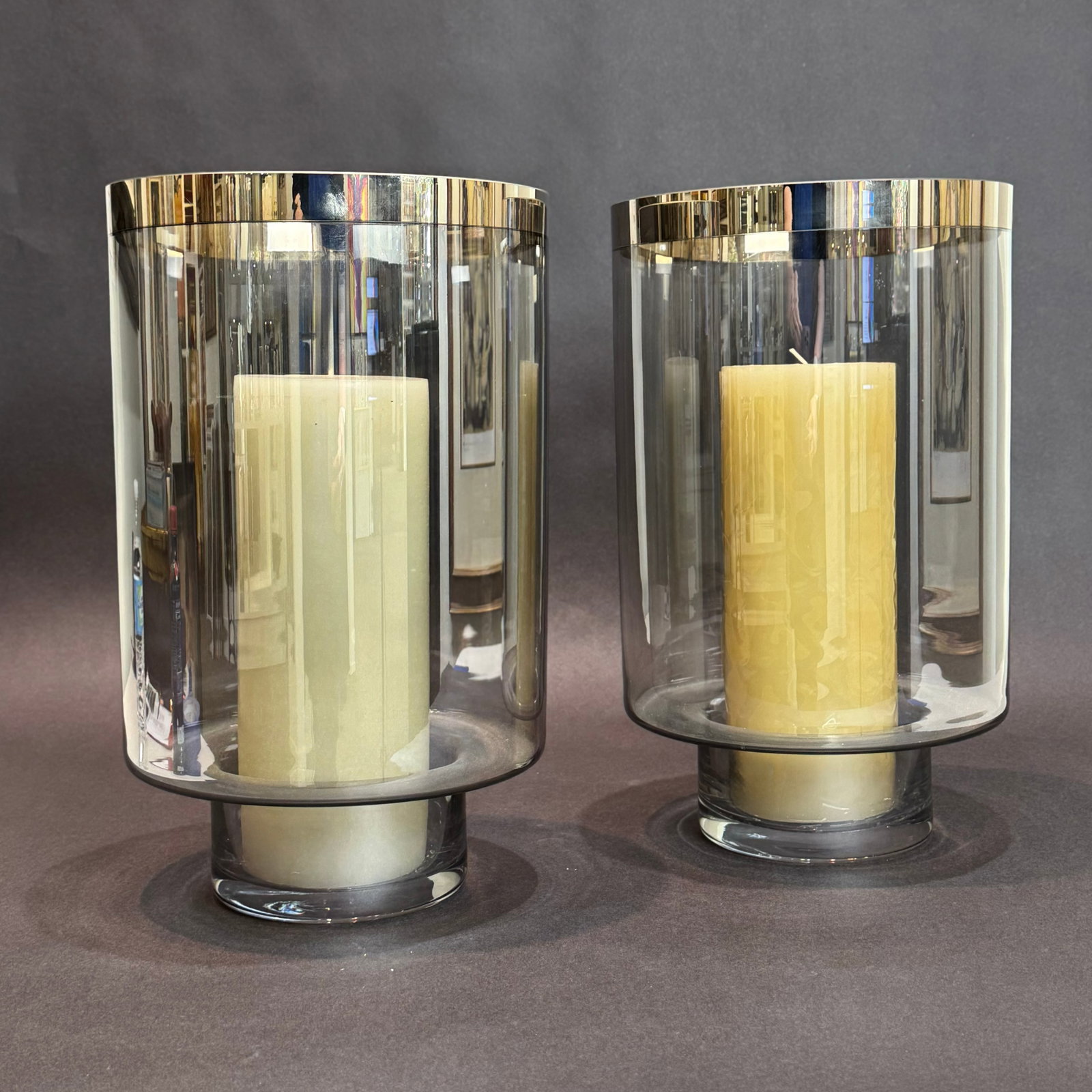 Global Views Set of 2 14 inch Glass Hurricanes with Candles: Artist: Global Views Title: Twilight Hurricane Set of 2 Medium: Hand Blown Smoked Glass with Decal Applied Platinum Rim Around Top Edge Size: 8.5 round x 14 h The Twilight hurricane candle holders ble