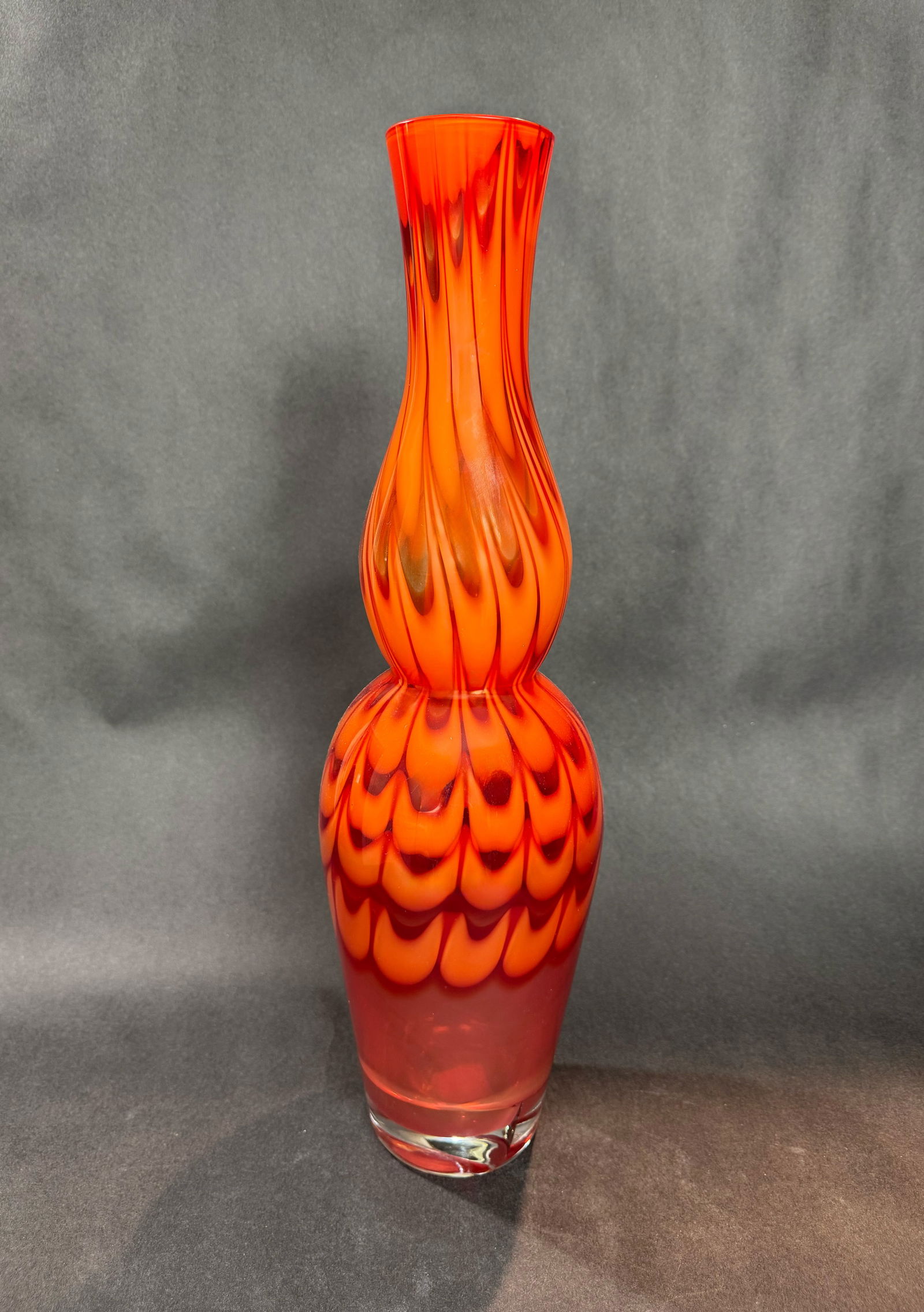 Waterford Crystal Evolution 20 H x 6 W Glass Vase: Artist: Waterford Crystal Evolution Title: Red & Amber Stem Vase Medium: Glass Size: 20 H x 26 W x 6 D Weight: 6.3 lbs. This sculptural vessel features an organic, undulating form that feels inspired