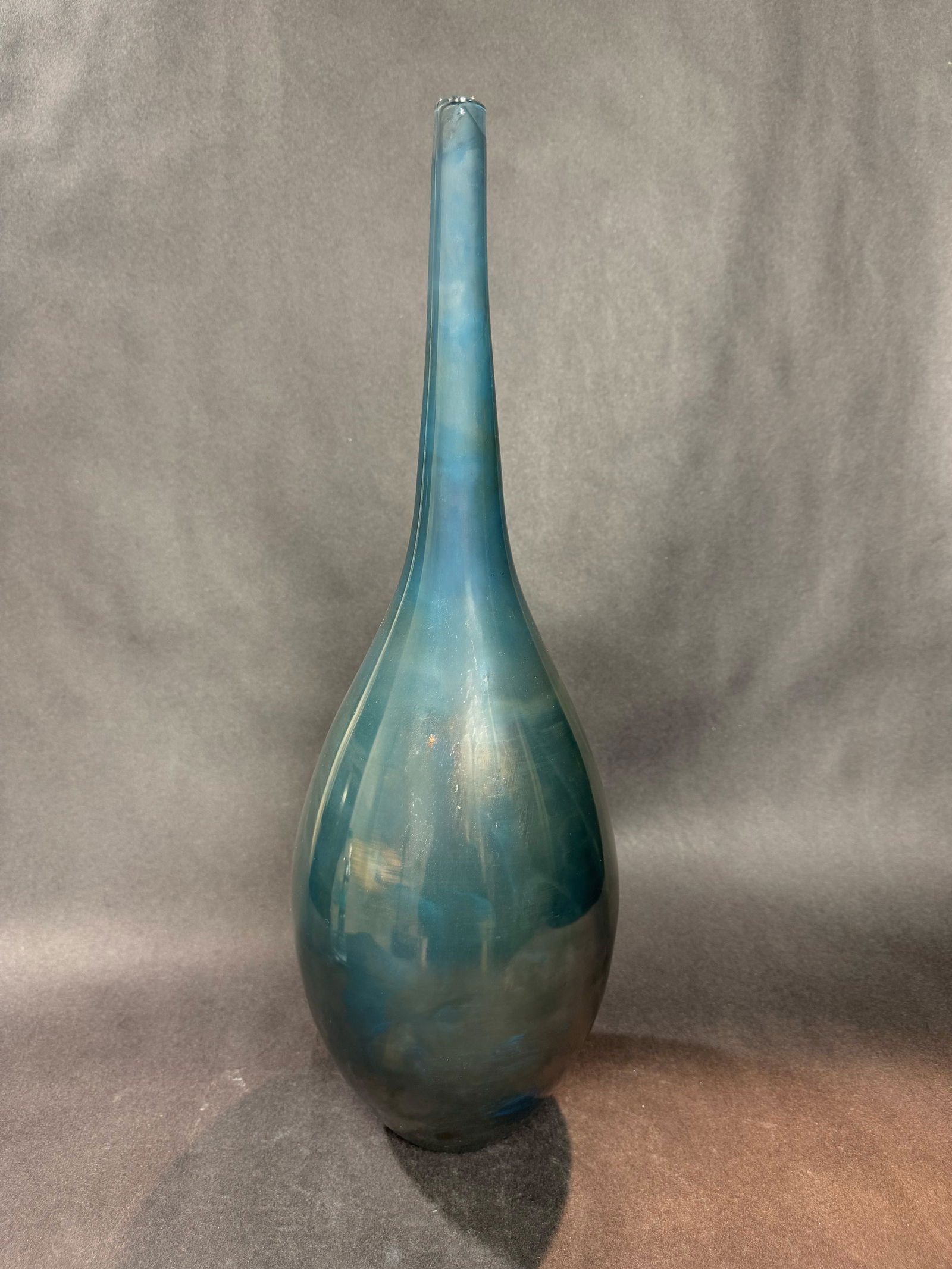 Cyan Design 21.5 H x 6.5 W Glass Vase: Artist: Cyan Design Title: Ariel Vase Medium: Glass Size: 21.5 H x 6.5 W x 6.5 D Weight: 3.35 lbs. This tall, elegant glass vase features a slender neck that flows into a softly rounded base, creatin