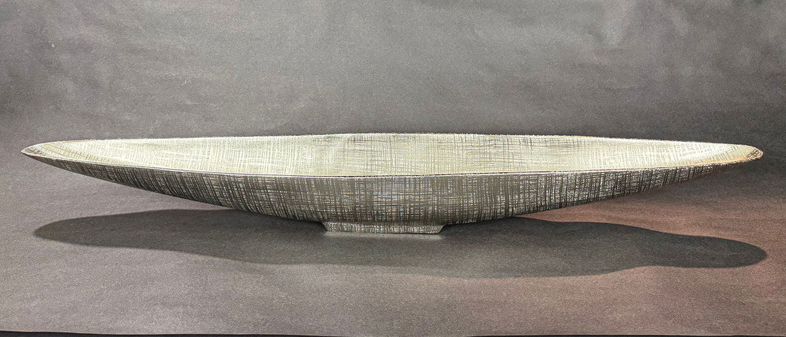 Cyan Design Silver Gondola Tray: Artist: Cyan Design Title: Silver Gondola Tray Medium: Hand-blown Glass Size: 4.25 h x 39.5 w x 6.25 d Weight: 5.3 lbs. Silver-toned vessel with an elongated, boat-like form and tapered ends, raised