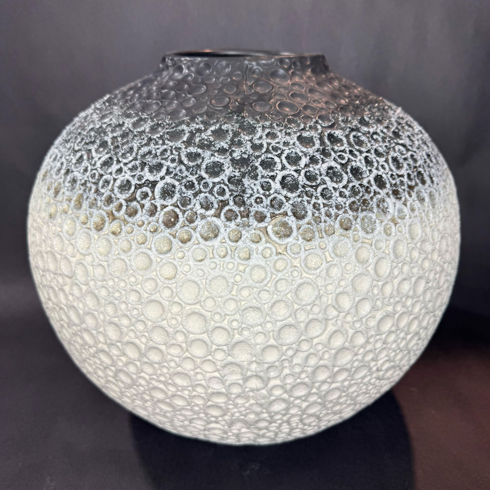 Global Views 14 H x 15 W Ceramic Vase: Artist: Global Views Title: Celestial Black & White Vase Medium: Ceramic Size: 14 H x 15 W x 15 D Weight: 11.25 lbs. This celestial-inspired vase features a rounded silhouette accented by a richly te