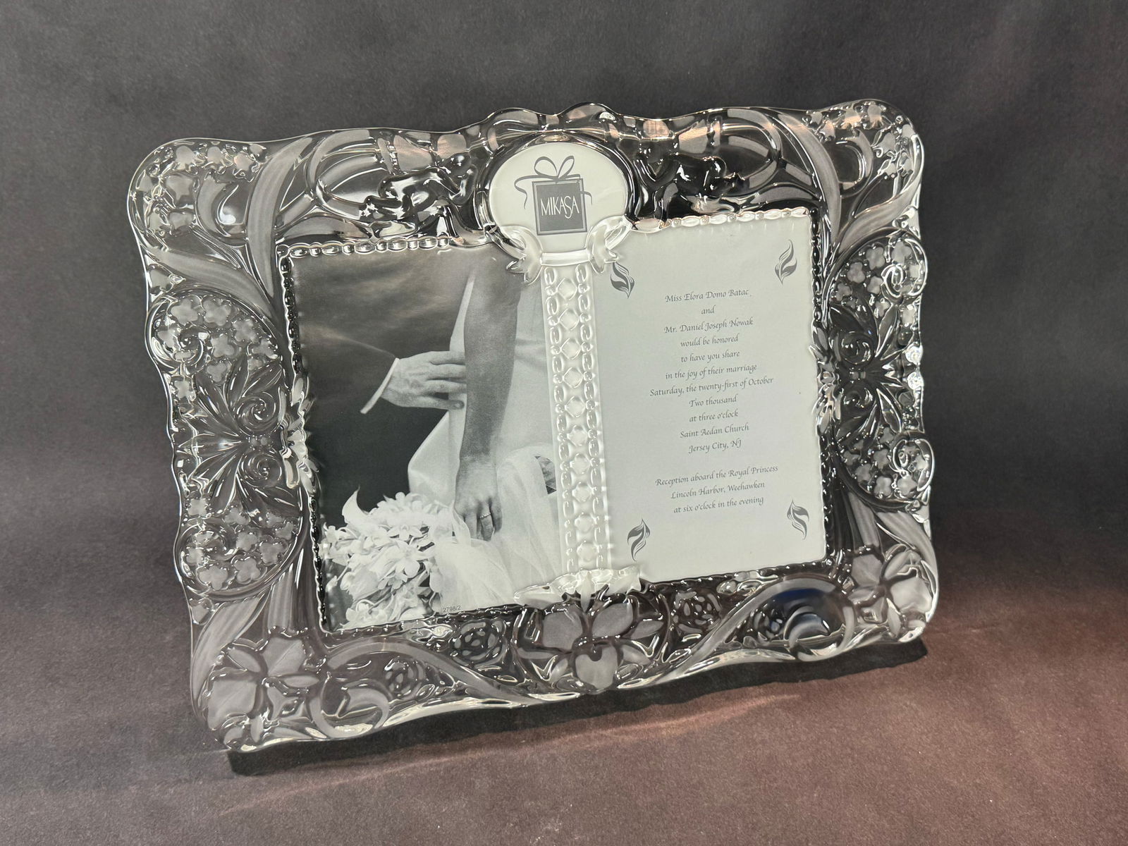 Mikasa 11.25 H x 14.75 W Glass Photo Frame: Artist: Mikasa Title: Cherished Moments Frame Medium: Glass Photo Frame Size: 11.25 H x 14.75W x 1 D Weight: 5 lbs. This elegant Mikasa frame features a beautifully sculpted glass design with intrica