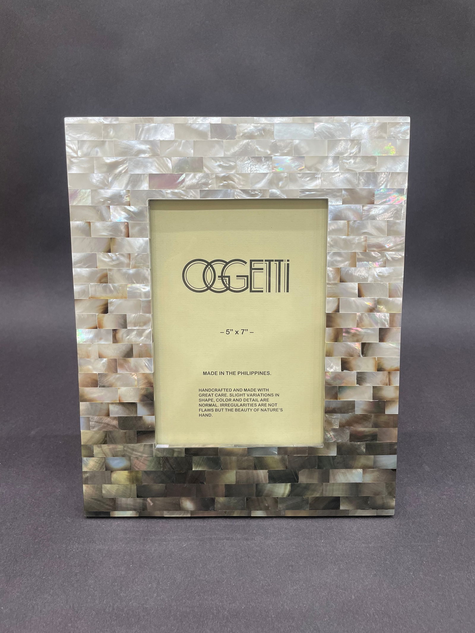 Oggetti Studios 10.5 H x 8.5 W Photo Frame: Artist: Oggetti Studios Title: 5x7 Shell Tile Frame Medium: Glass Size: 10.5 H x 8.5 W x 0.5 D Weight: 1 lbs. This refined picture frame is crafted from hand-set tiles of luminous shell, creating a s