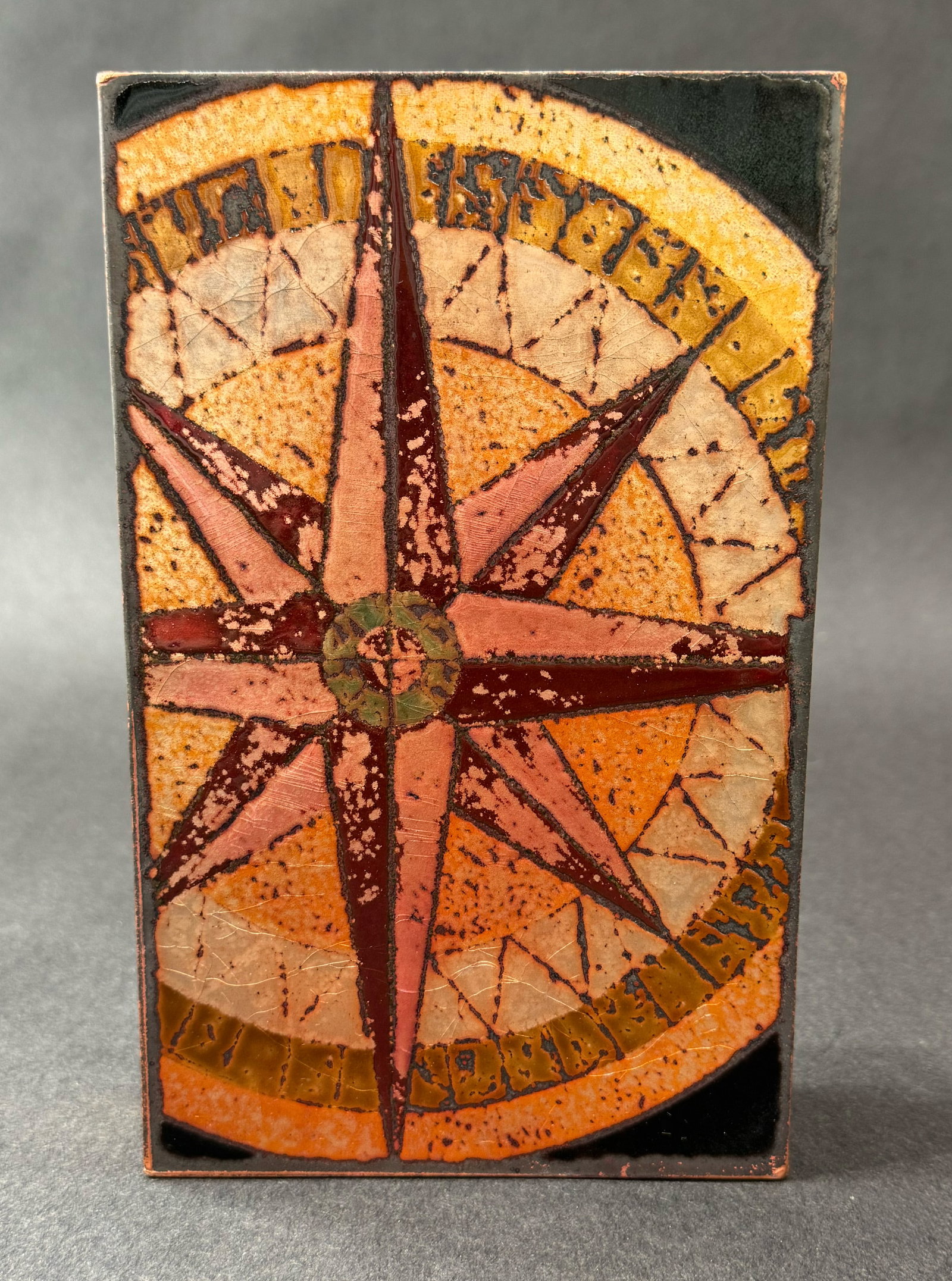 Houston Llew 8.5" H x 5.25" WRetired Spiritile 162: True North: Artist: Houston Llew (b. 1980s) American Title: 162: True North RETIRED Medium: Copper and Enamel on Wood Artwork Size: 8.5 H x 5.25 W x 1.75 D Weight: 2.5 lbs. Edition: Open This evocative mixed-medi