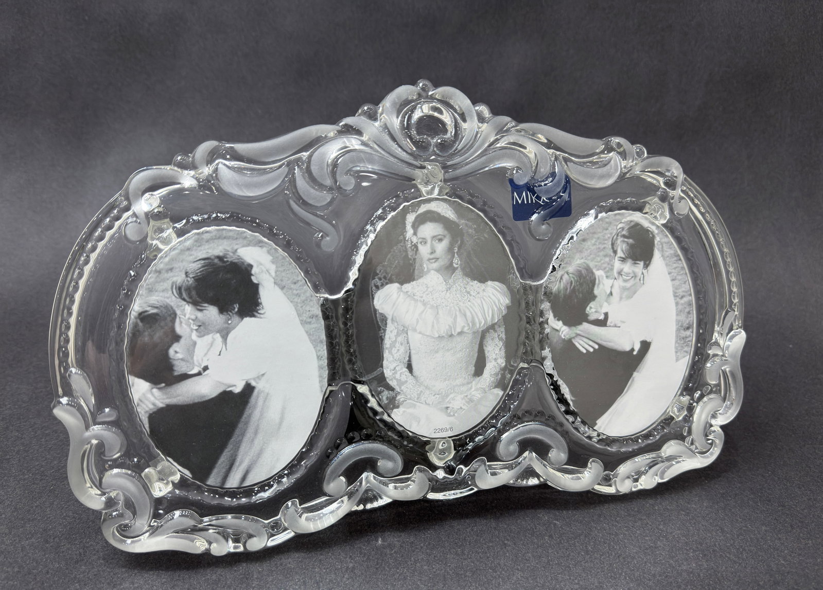 Mikasa 8" H x 13" W Cherished Moments Triple Oval Frame: Artist: Mikasa Title: Cherished Moments Triple Oval Frame Medium: Glass Photo Frame Size: 8" H x 13" W x 3" D Weight: 2.5 lbs. Edition: Open This elegant Mikasa frame features a beautifully sculpte