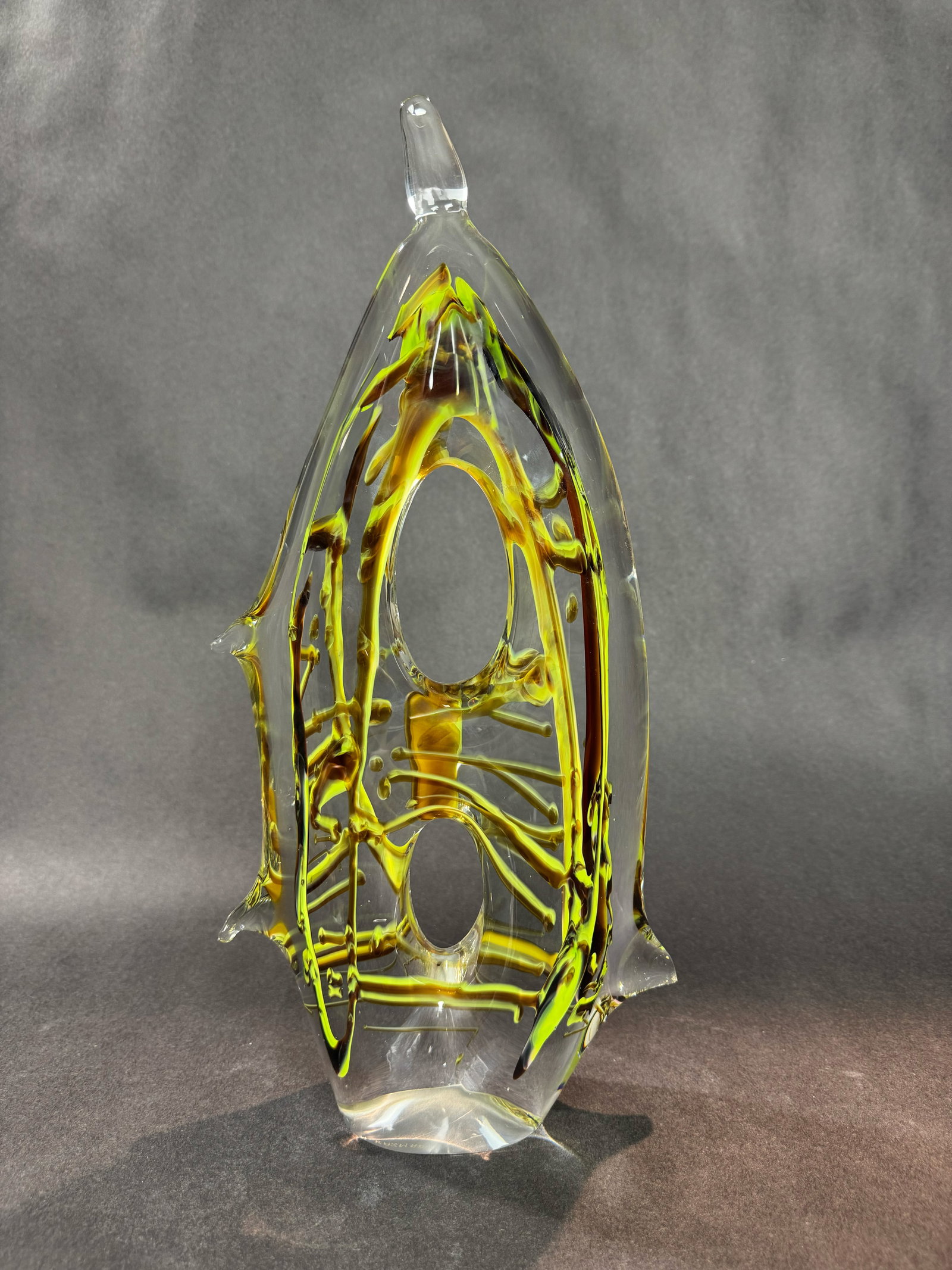 Kazam Glass Studio 15.5” H x 7.5” W Glass Sculpture: Artist: Kazam Glass Studio Title: Green Glass Sculpture Medium: Glass Size: 15.5” H x 7.5” W x 2” D Weight: 10 lbs. Edition: Unique This striking glass sculpture features a tall