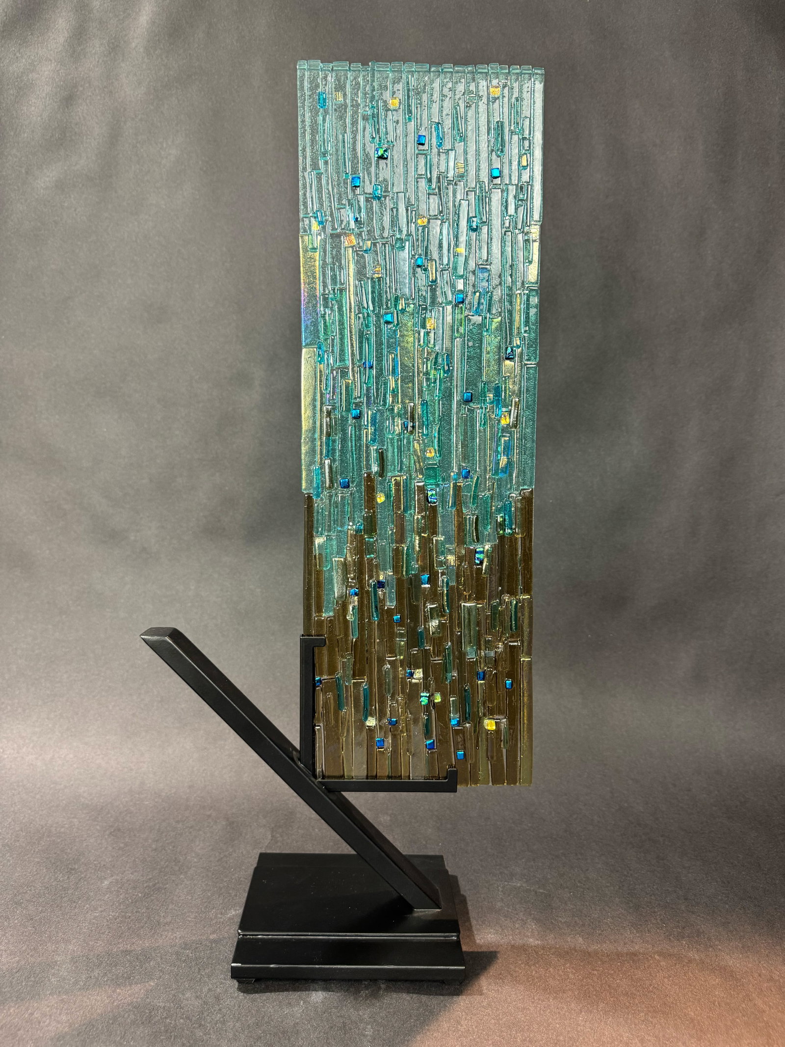 Alicia Kelemen 22” H x 10” W Sandy Sea Aqua Original Sculpture : Artist: Alicia Kelemen (b. 1960s) Venezuelan Title: Sandy Sea Aqua II Medium: Fused Glass with Steel Base Artwork Size: 22” H x 10” W x 5” D Weight: 6.5 lbs. Edition: Original Certif