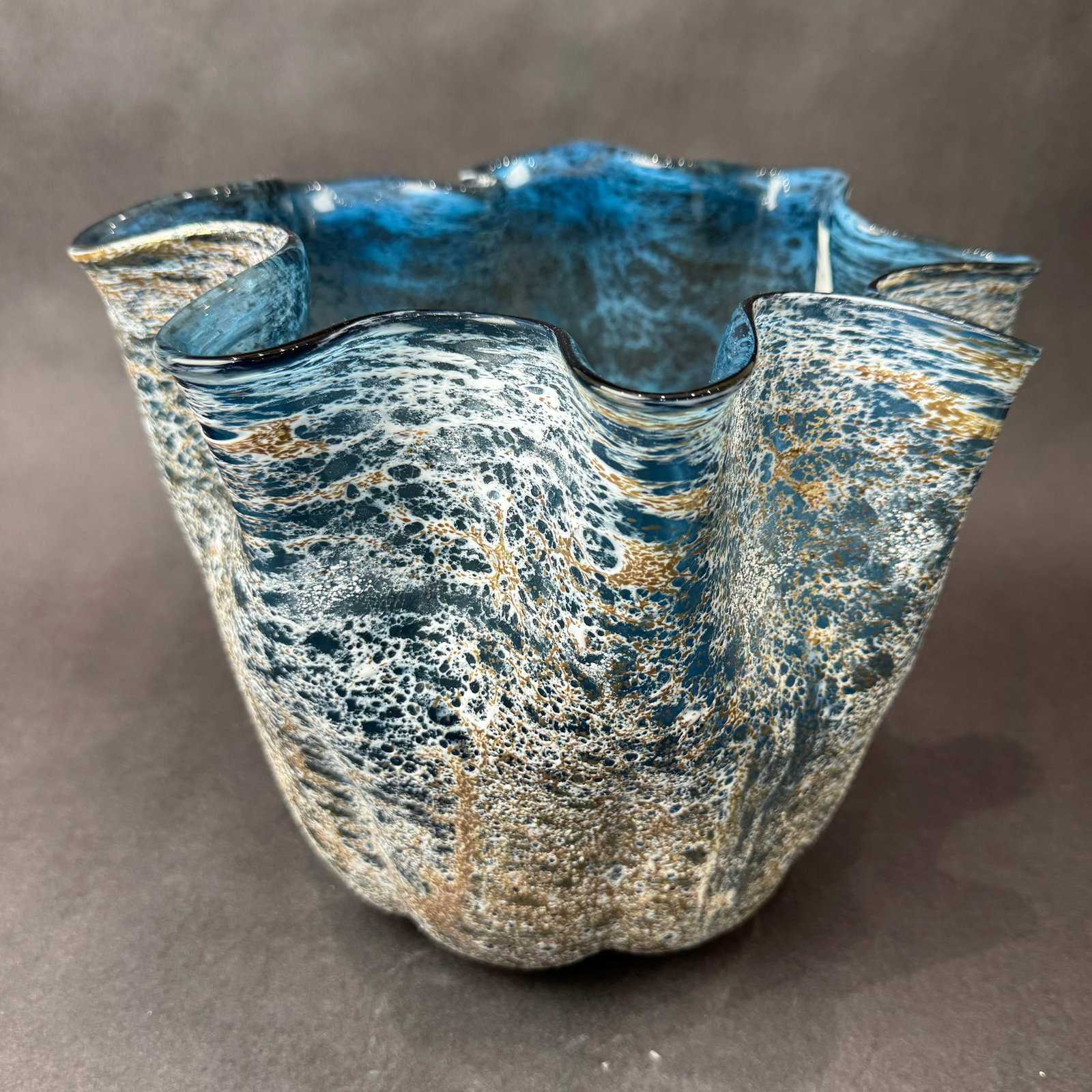 Cyan Design 9" H x 12.75" W Meduse Blue & Gold Vase: Artist: Cyan Design Title: Meduse Blue & Gold Vase - 9" Medium: Glass Artwork Size: 9" H x 12.75" W x 12.75" D Weight: 7.1 lbs. Edition: Unique This striking hand-blown glass vase features a softly