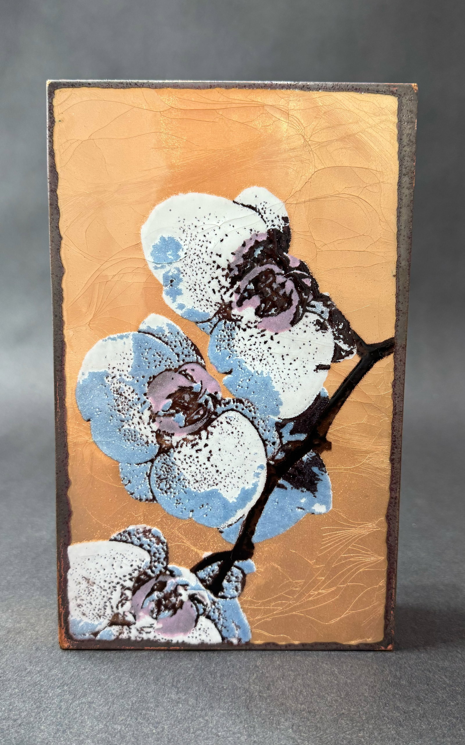 Houston Llew 8.5" H x 5.25" W Retired Spiritile 260: Bloom: Artist: Houston Llew (b. 1980s) American Title: 260: Bloom RETIRED Medium: Copper and Enamel on Wood Artwork Size: 8.5" H x 5.25" W x 1.75" D Weight: 2.5 lbs. Edition: Open This mixed-media artwork co