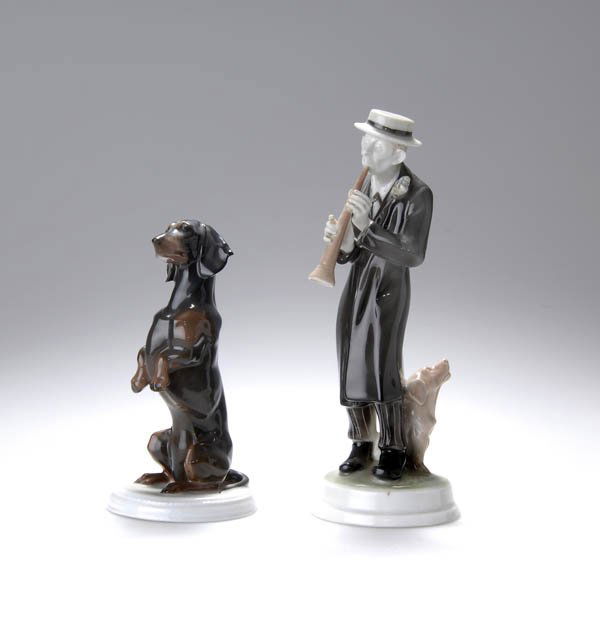 Fritz Diller, 'Sitzender Dackel', 1913: Auf den Hinterläufen sitzend und 'Männchen' machend; runder, flacher Sockelstand. H. 15 cm. Ausführung: Ph. Rosenthal, Selb, um 1920. Weißer Porzellanscherben, glasiert; Unterglasurbemalung in Hel