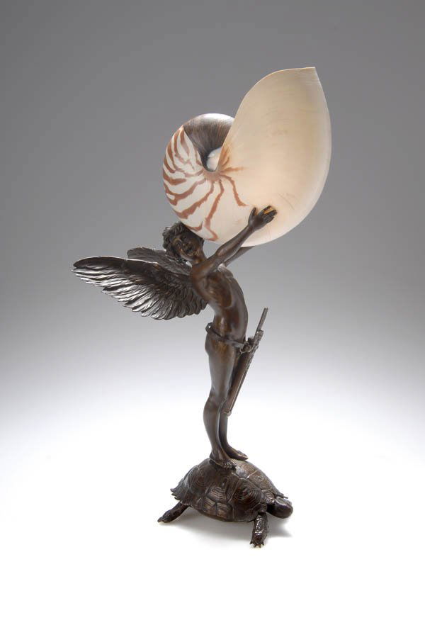 790: Stuck, Franz von; Kunstanstalt für Galvanoplastik,: Winged Amor boy standing on a tortoise shell holding a real nautilus shell with both hands, a quiver with darts hanging from his belt. H. 42.5 cm. Executed by Kunstanstalt fuer Galvanoplastik, Munich.