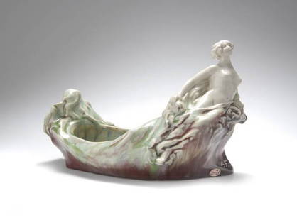 Alfred Finot, Nancy, Jardinière 'La vague', around: Figure of a girl dressed in a veil. H. 16.5 cm; appr. 26 x 16.5 cm. Executed by Mougin Frères ceramic manufacture, Nancy. Light-color clay material. MarkedFrancine Bertrand, Joseph et Pierre Mougin,