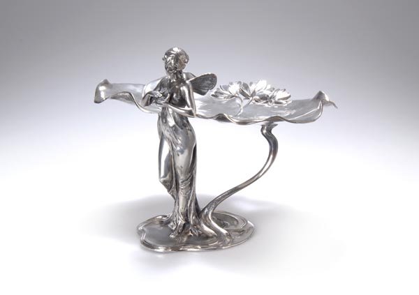 WMF, Geislingen, Visitors' card plate, ca. 1900: Britannia metal, silver-plated. Marked. H. 21.6 cm. Cat. Art Nouveau Domestic Metallwork from WMF 1906, Hrsg. Graham Dry, Nachdruck Woodbridge 1988, Farbtafel VII u.Tafel 167, Abb. Mitte links.