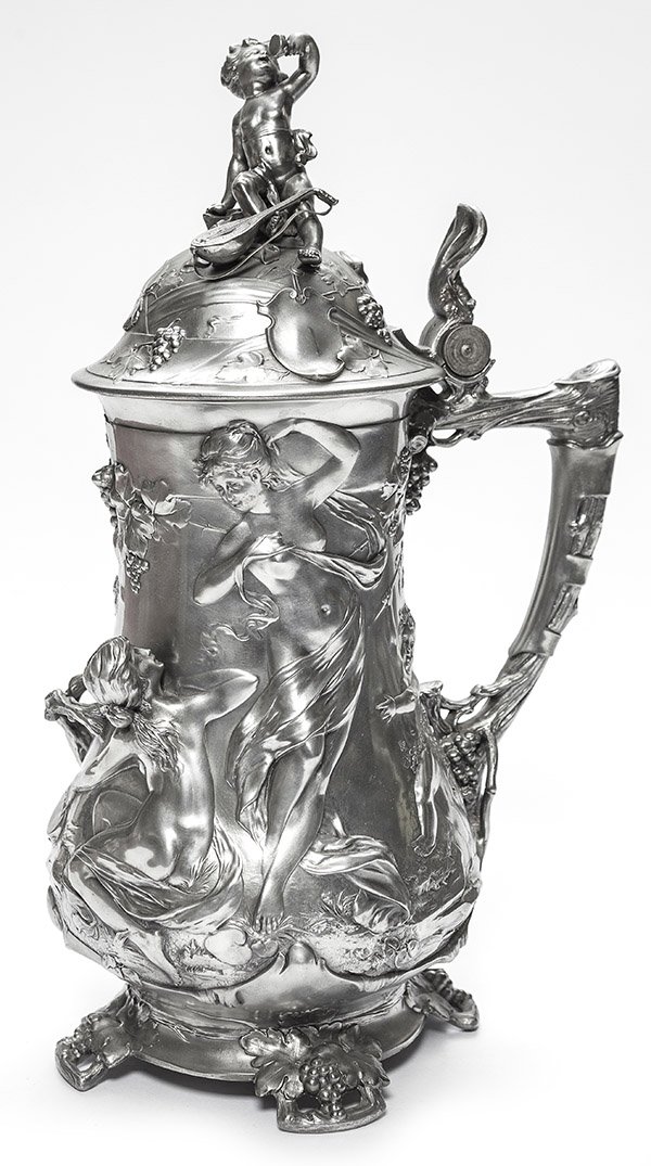 European Wine Cooler: European pewter wine cooler, lidded form with single handle is heavily chased in relief featuring a satyr, nymphs and cherub among the reticulated trees and numerous grape clusters and vines, finial d