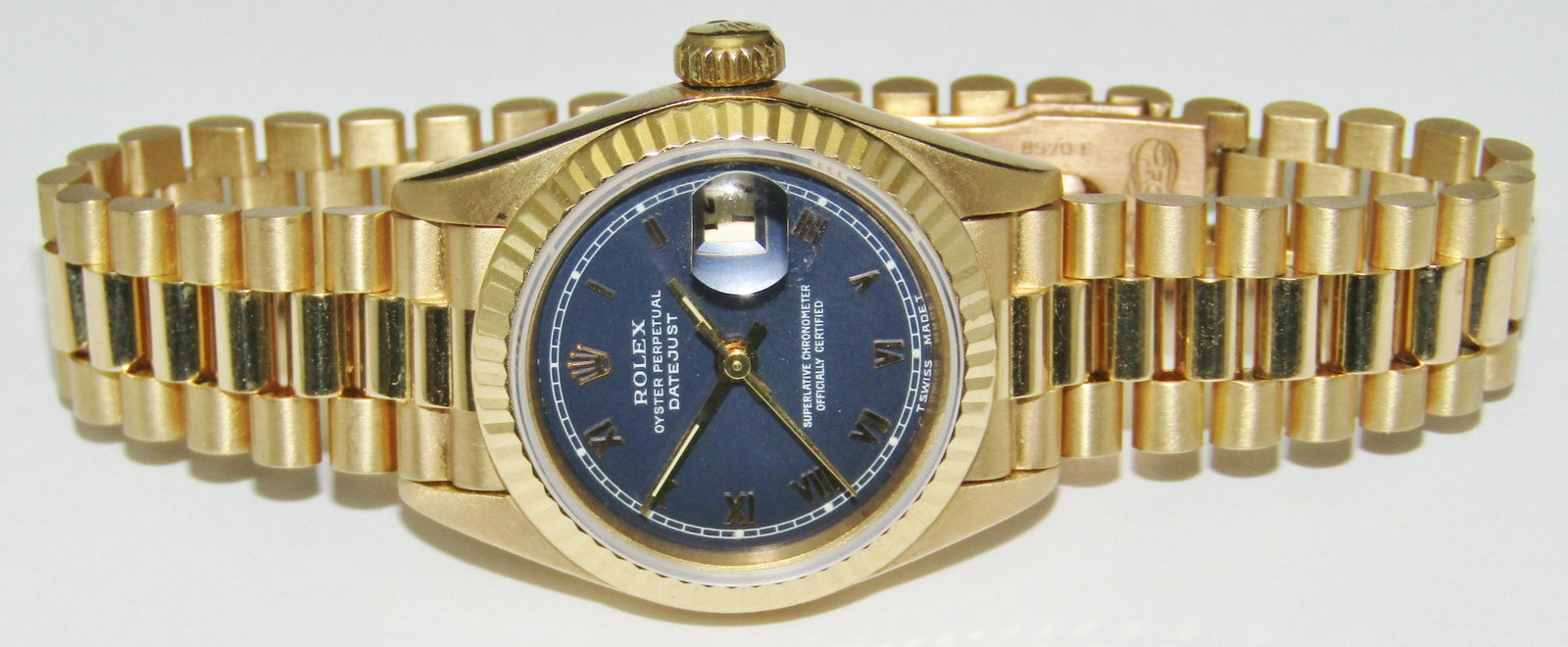18 Kt Gold Rolex Presidential watch: 18 karat yellow gold Rolex Presidential wristwatch, 26 mm model #69178, with blue dial, circa 1990 to 1996. Case number was unobtainable because bracelet could not be removed. 20.5 cm bracelet, 14.5 c