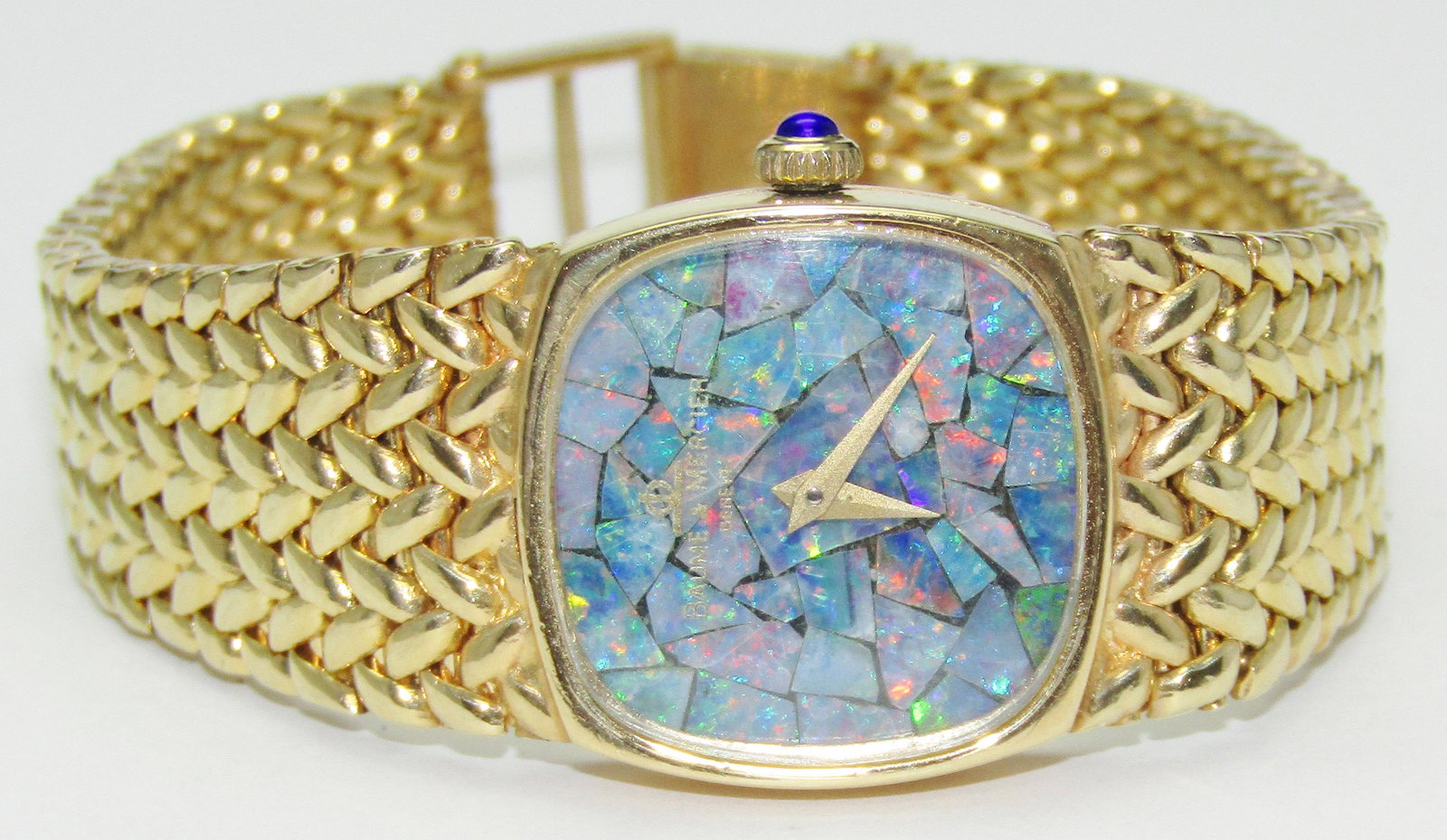 14kt yellow gold ladies BAUME & MERCIER dress watch: 14 karat yellow gold ladies BAUME & MERCIER dress watch, 28 mm. Opal mosaic dial. Sapphire thumb button. 16 cm bracelet when latched. Appraised Fair Market Value (FMV) is $2500.