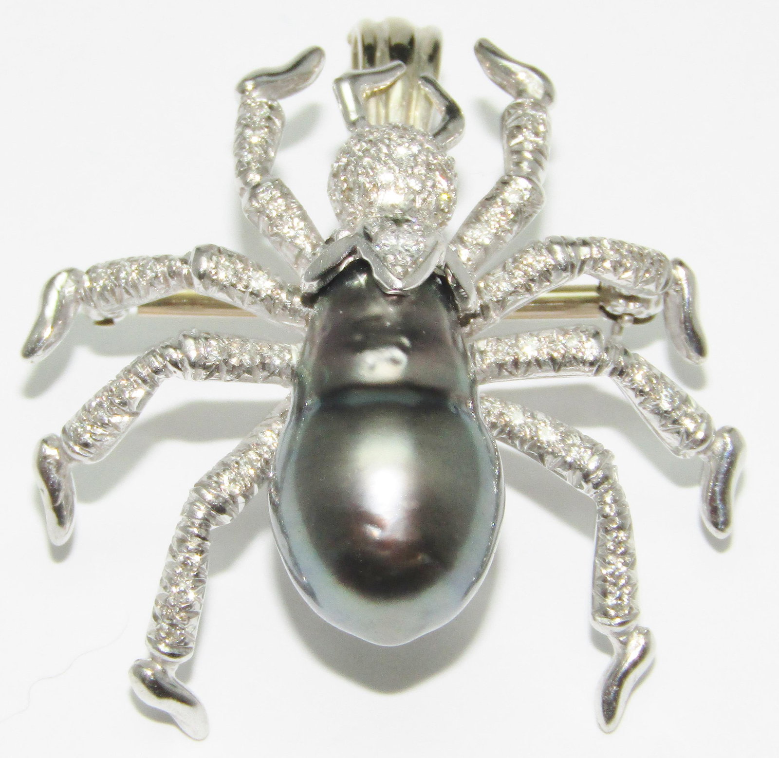 Hammermens Bros 18Kt Gold Spider Pin/Pendant with Tahitian Pearl and Diamond Melee: 18 karat yellow gold spider pin/pendant with 1 Tahitian pearl with diamond melee. 14.0 grams. Marked: HB (for HAMMERmens BROS). Appraised Fair Market Value (FMV) is $3000.