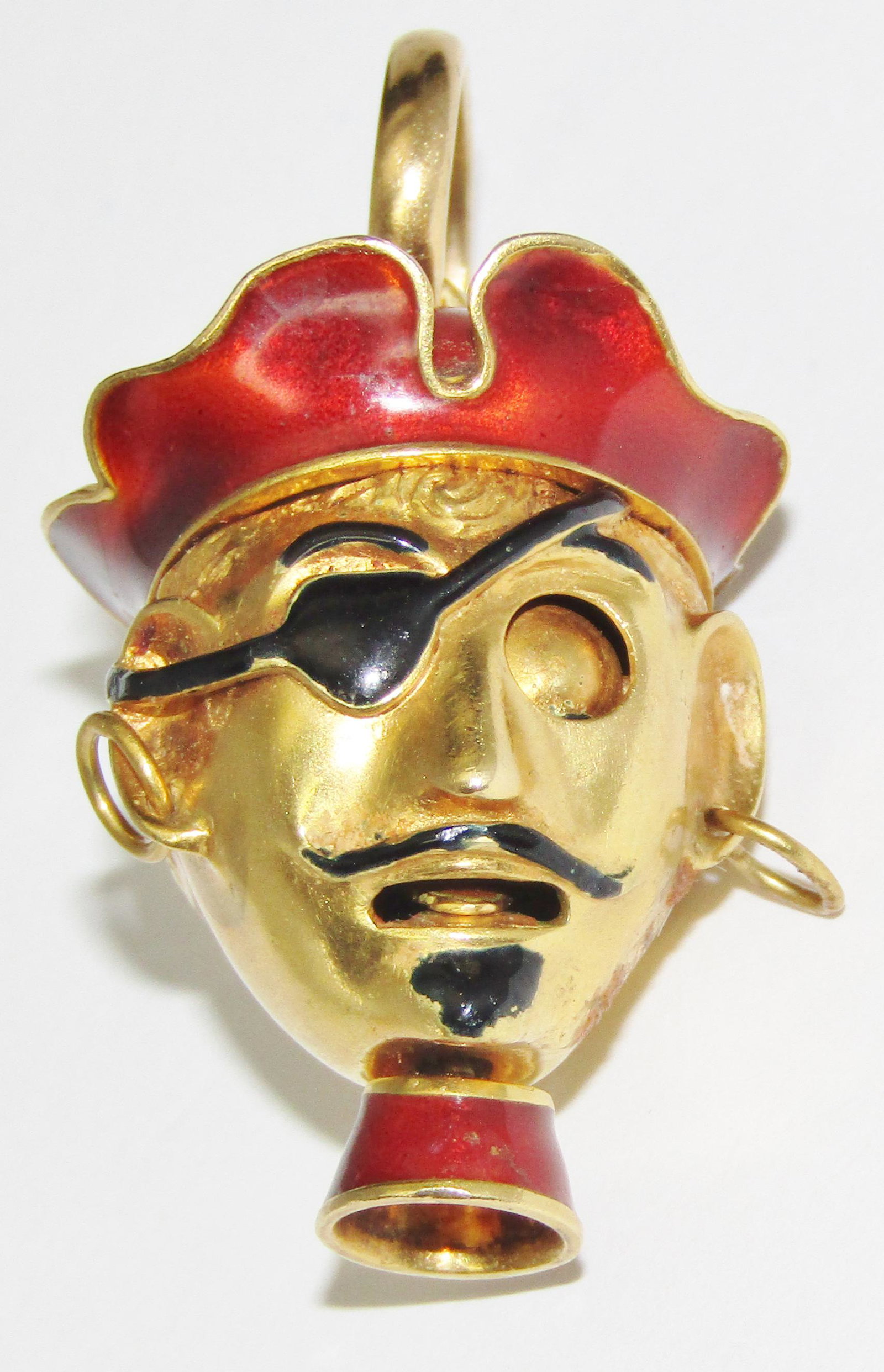 18Kt Gold and Enamel Pirate Charm: 18 karat yellow gold mechanical Pirate head charm with red & black enamels. 24.6 grams. Appraised Fair Market Value (FMV) is $1000.