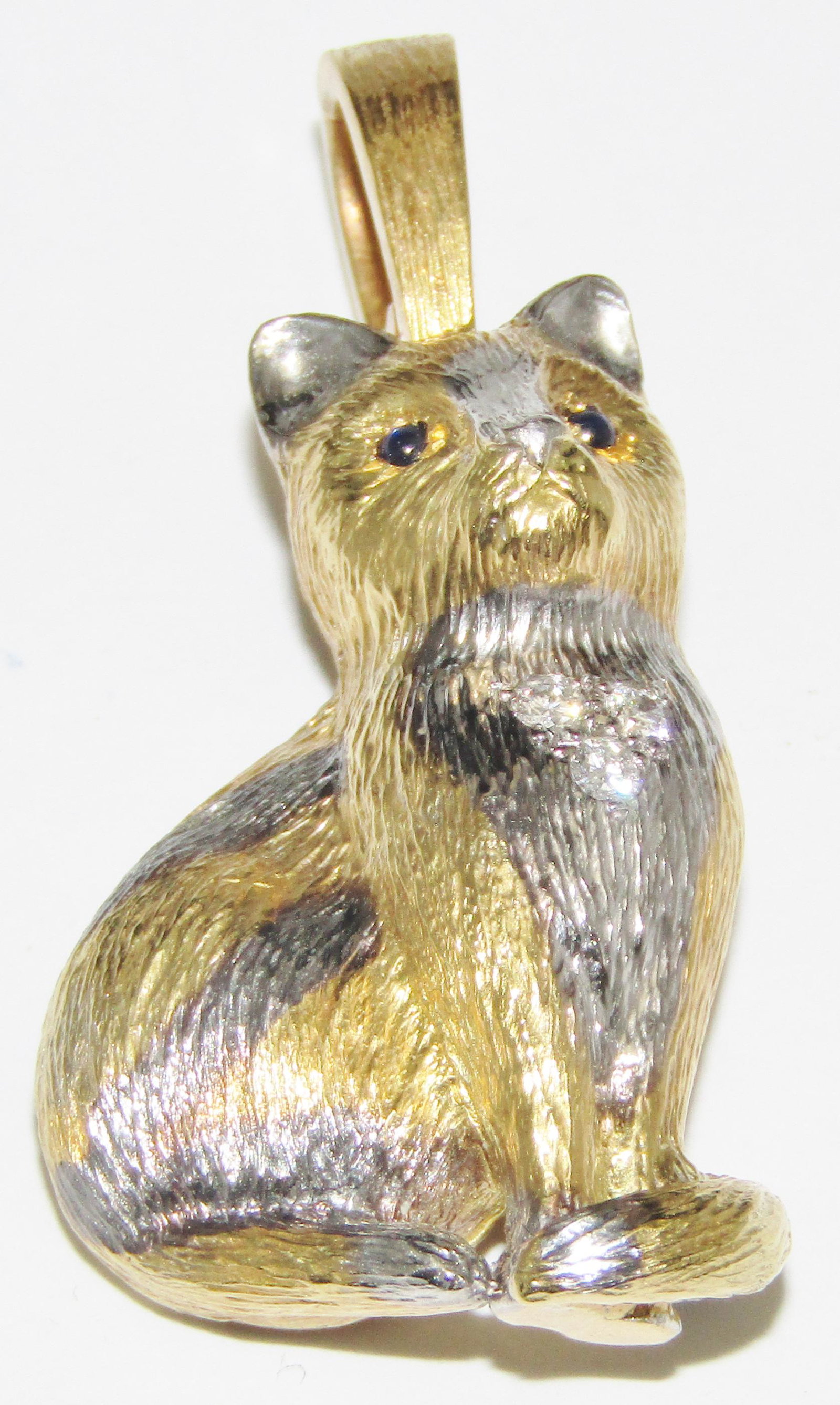 18Kt Gold Cat Pendant with Sapphires and Diamonds: 18 karat yellow gold (has white gold embellishments) Cat pendant with 2 cabochon sapphire eyes and has 3 diamond melee in the chest. 16.2 grams. Appraised Fair Market Value (FMV) is $700.