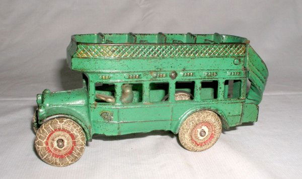 ARCADE DOUBLE DECK COACH BUS: ARCADE DOUBLE DECK COACH BUS circa 1929 - 8" long. Lovely double deck bus still displaying plenty of gold accents on the trim. Finished in green with fatigued rubber tires and nickeled driver. Arcade