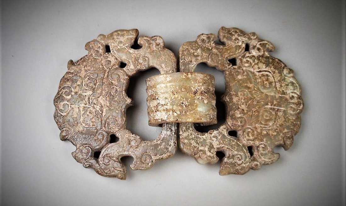 A CHINESE ARCHAIC WHITE JADE CARVED DOUBLE BUCKLES: SHANG DYNASTY 1766-1121 B.C. A CHINESE ARCHAIC WHITE JADE CARVED DOUBLE BUCKLES 4.5 inx2.5 in (11x6.5 cm) Provenance: Property from a private Taiwan collector, purchased in 1930 from Hong Kong (ࢇ