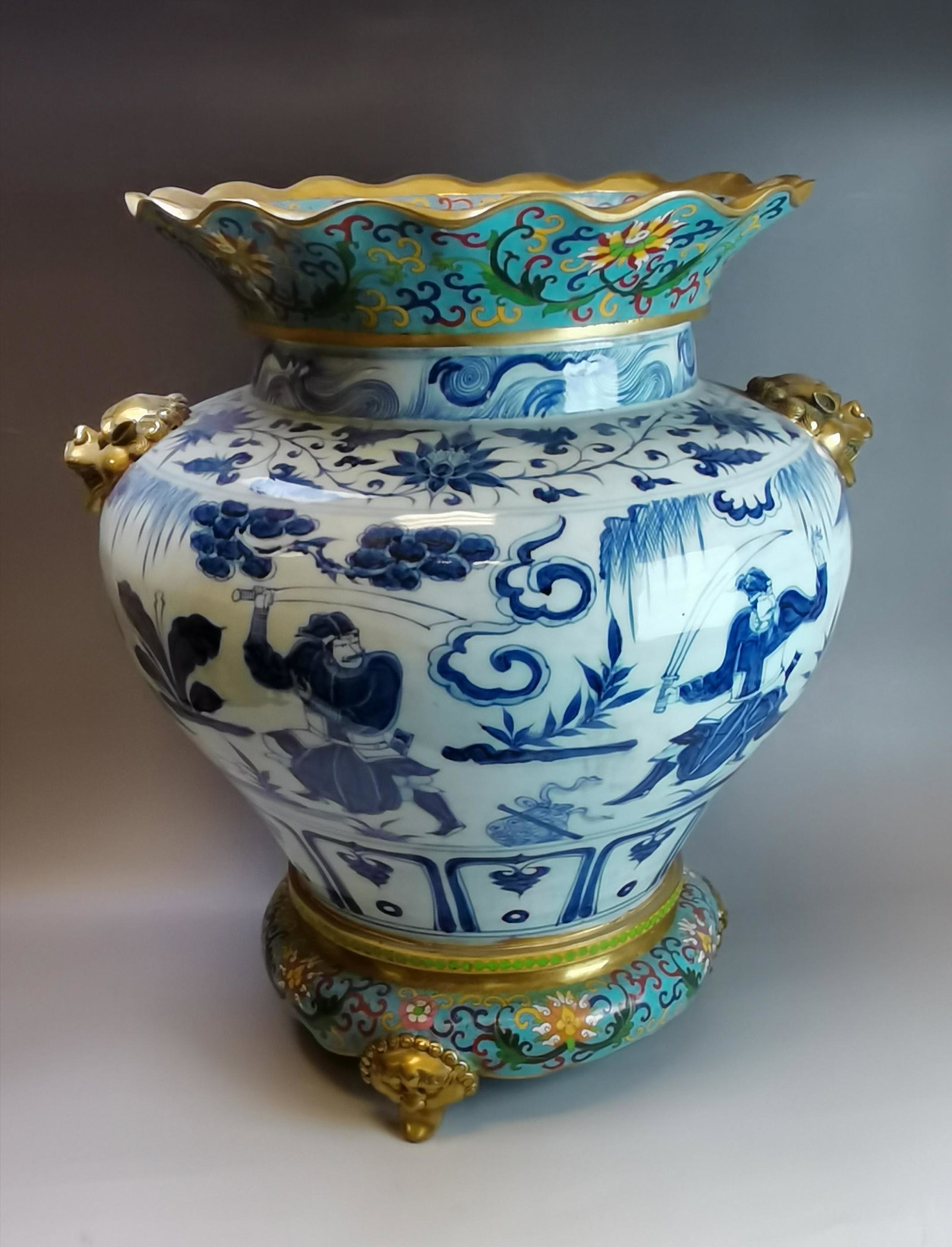A large Chinese Yuan style blue and white porcelain jar: A large Chinese Yuan style blue and white porcelain jar with cloisonne bottle mouth edge and tripod, 42x38cm. Shipping: We are able to pack and ship this item to an address in the United States for $1