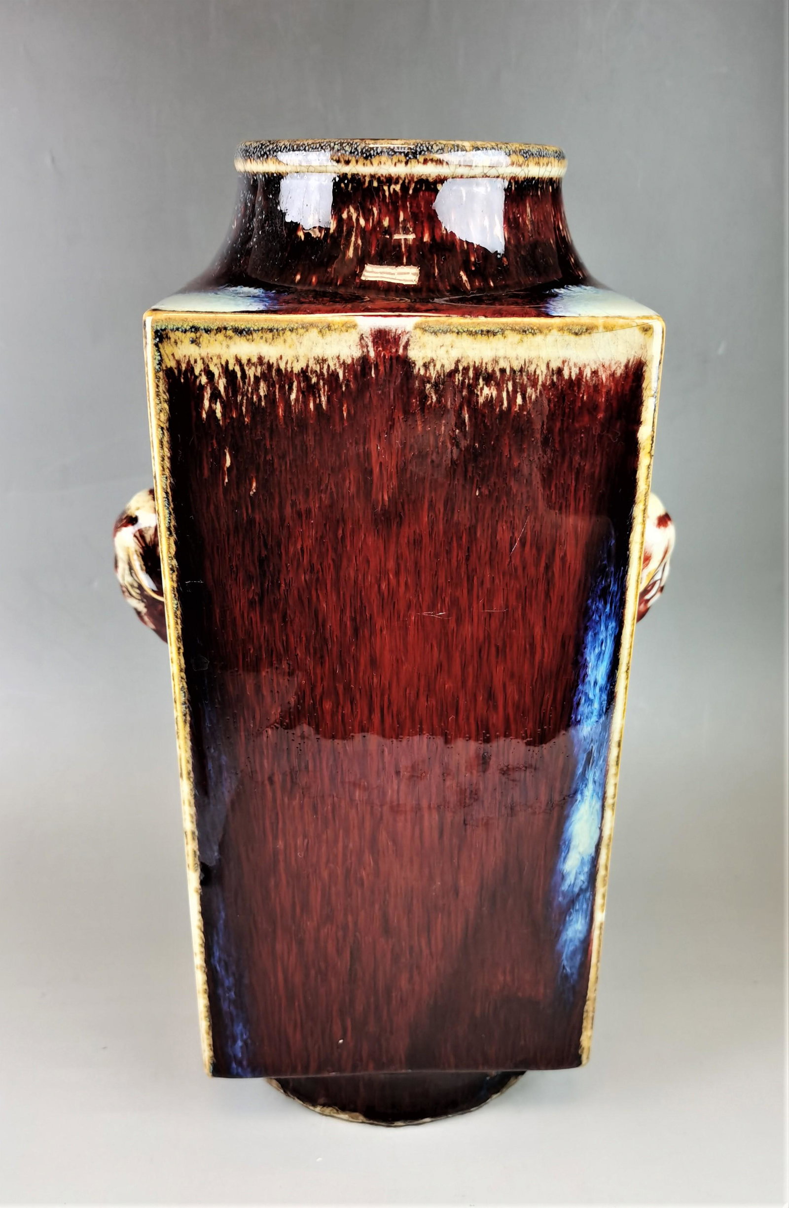 A Chinese red glazed porcelain vase: A Chinese red glazed porcelain vase, [Yongzheng] mark, 29.5x12 cm. Provenance: from the collections of Mrs. Alice Marie Hazell (1935-2017). Shipping: We are able to pack and ship this item to an addre