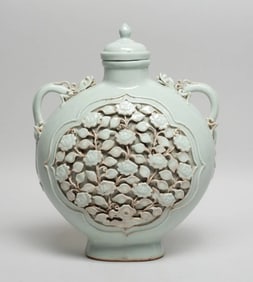 Chinese white glazed carved porcelain double eared vase with lid