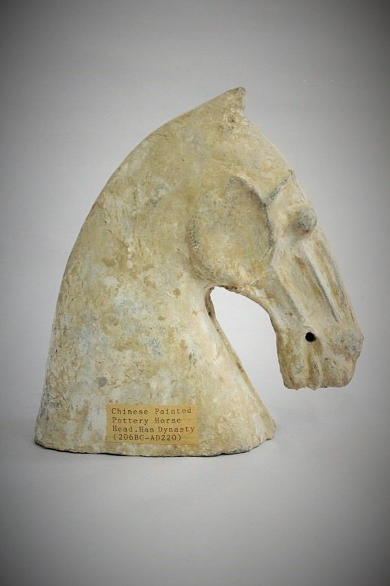 A Chinese han-dynasty pottery horse head: A Chinese han-dynasty pottery horse head, (two ears chip), 27.5cm H