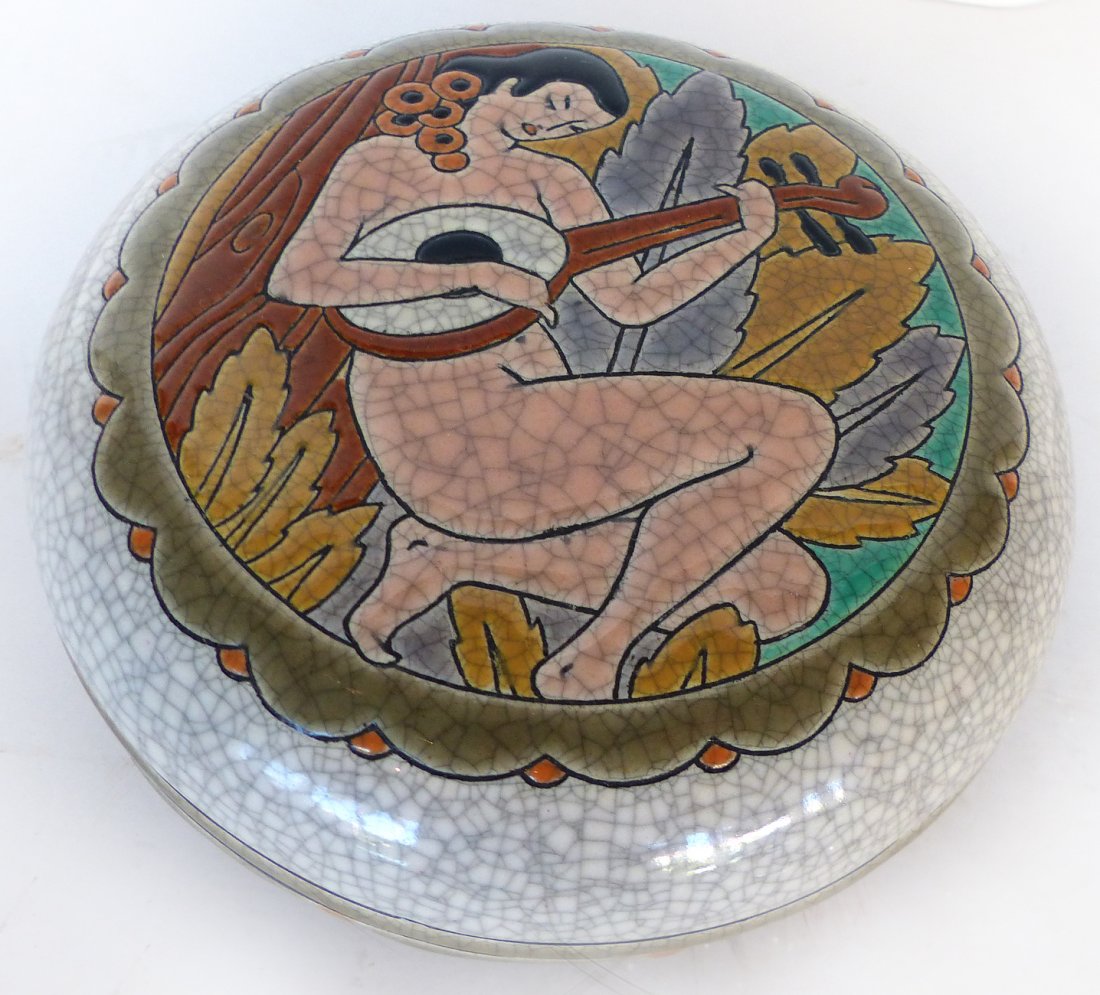 Longwy French Art Deco Lidded Box c. 1920-1930: Longwy French Art Deco lidded box c. 1920-30. W. 5 1/2\". H. 2 1/2\". Reclining nude figure with musical instrument. Signed Longwy, Pomone Atelier D\' Art, Bon Marche.