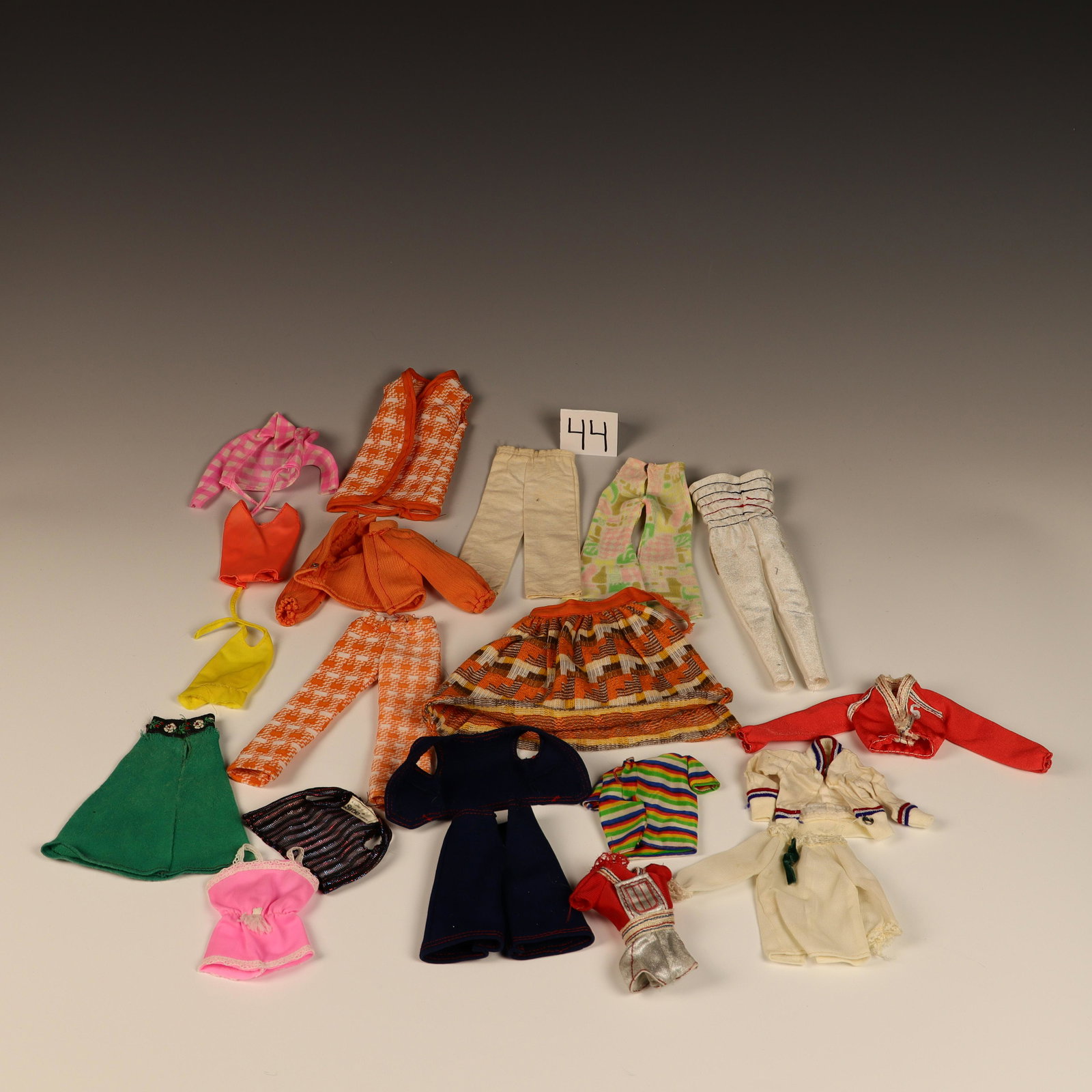 Vintage 60s 70s Mod Era Barbie clothing: 4 pairs of pants, two skirts a hat, 12 shirts