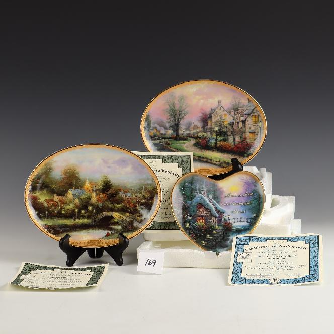 Three Thomas Kinkade art 2 oval collectible plates and one heart shaped: Three Thomas Kinkade art 2 oval collectible plates 8 ¾ X 6.5 inches with COAs and foam packs and one heart shaped Home is Where Our Hearts Feel Welcome 6X6 inches