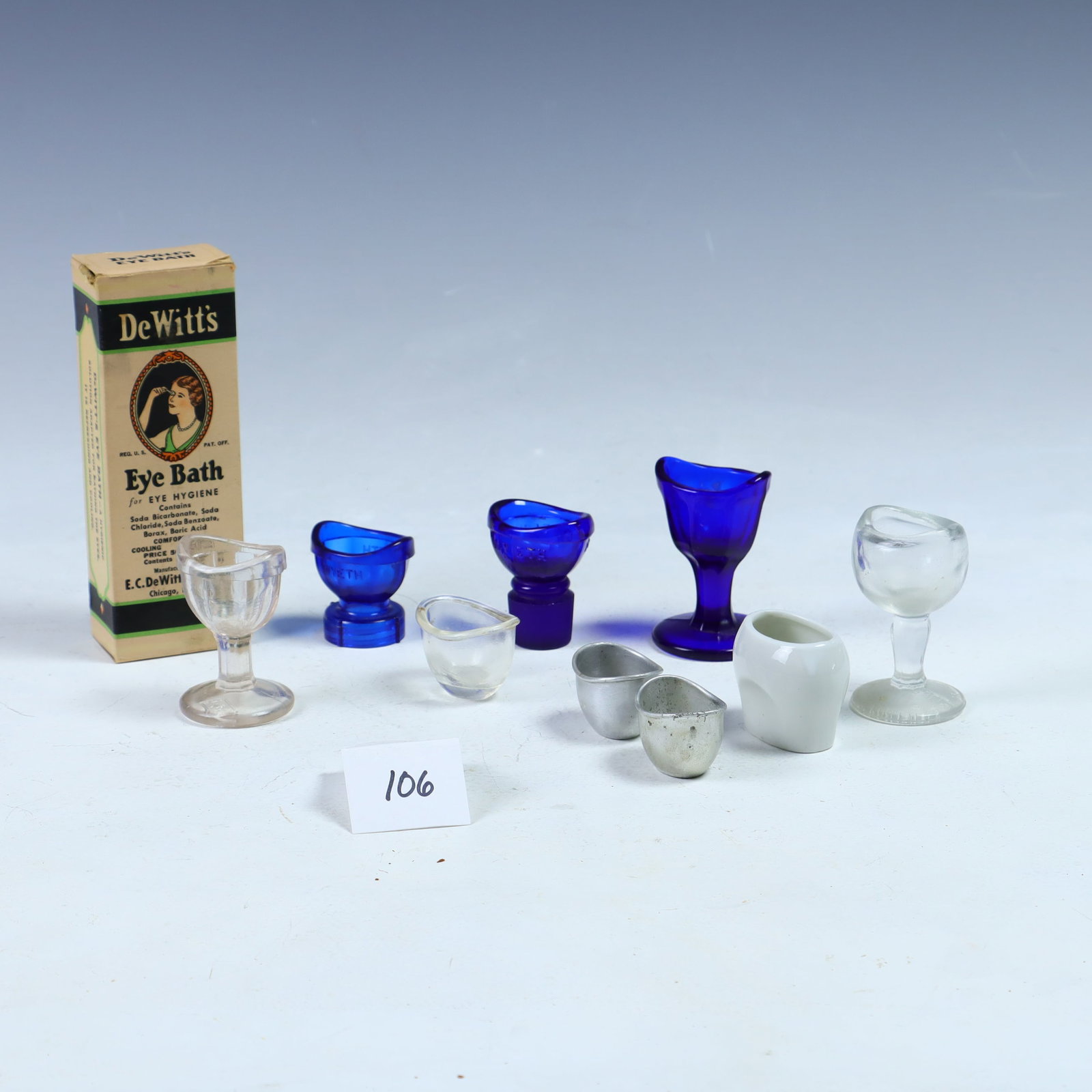 Lot of antique eye cups: Lot of antique eye cups, porcelain, glass, metal Mckessonâ€™s, plastic, and DeWittâ€™s eye bath bottle with eye cup