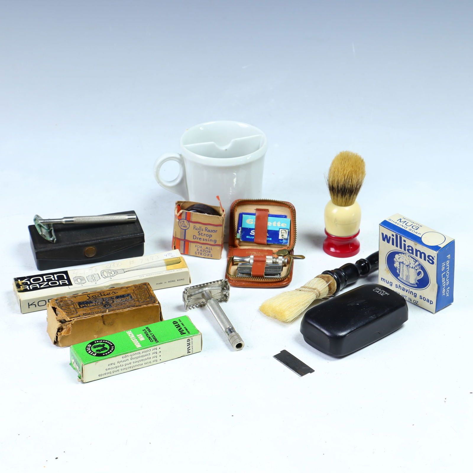 Antique porcelain shaving mug, brushes, strop dressing, shaving razors and more: Antique porcelain shaving mug, brushes, strop dressing, shaving razors by Korn razor, Moustache wax , Gillette razor, Pumice stone, Keen Kutter Junior