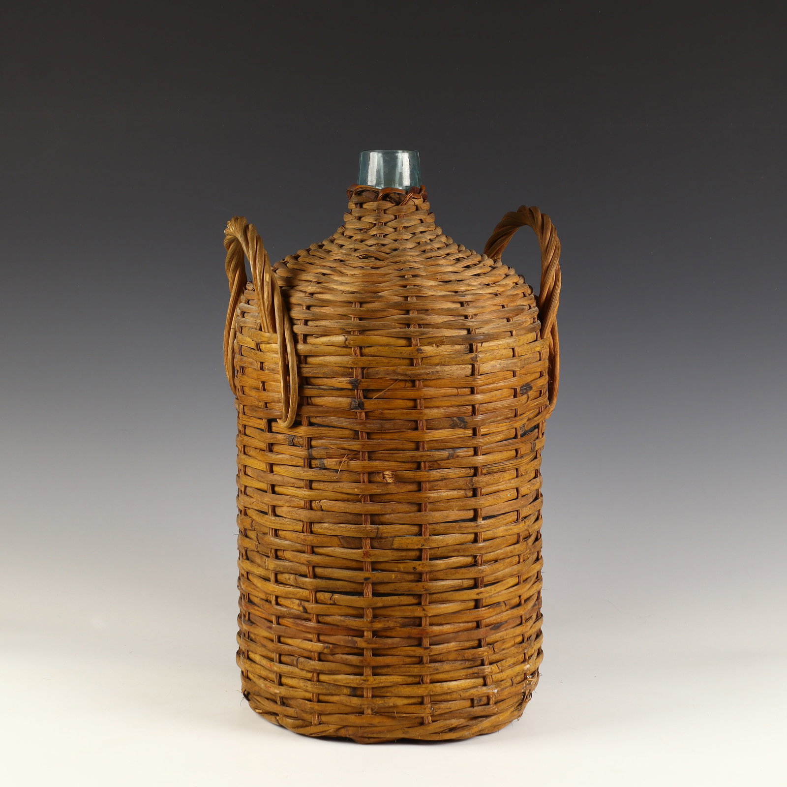 Vintage Glass Wine Jug wrapped in hand woven wicker: Vintage Glass Wine Jug wrapped in hand woven wicker 20 inches tall, 11 inches diameter