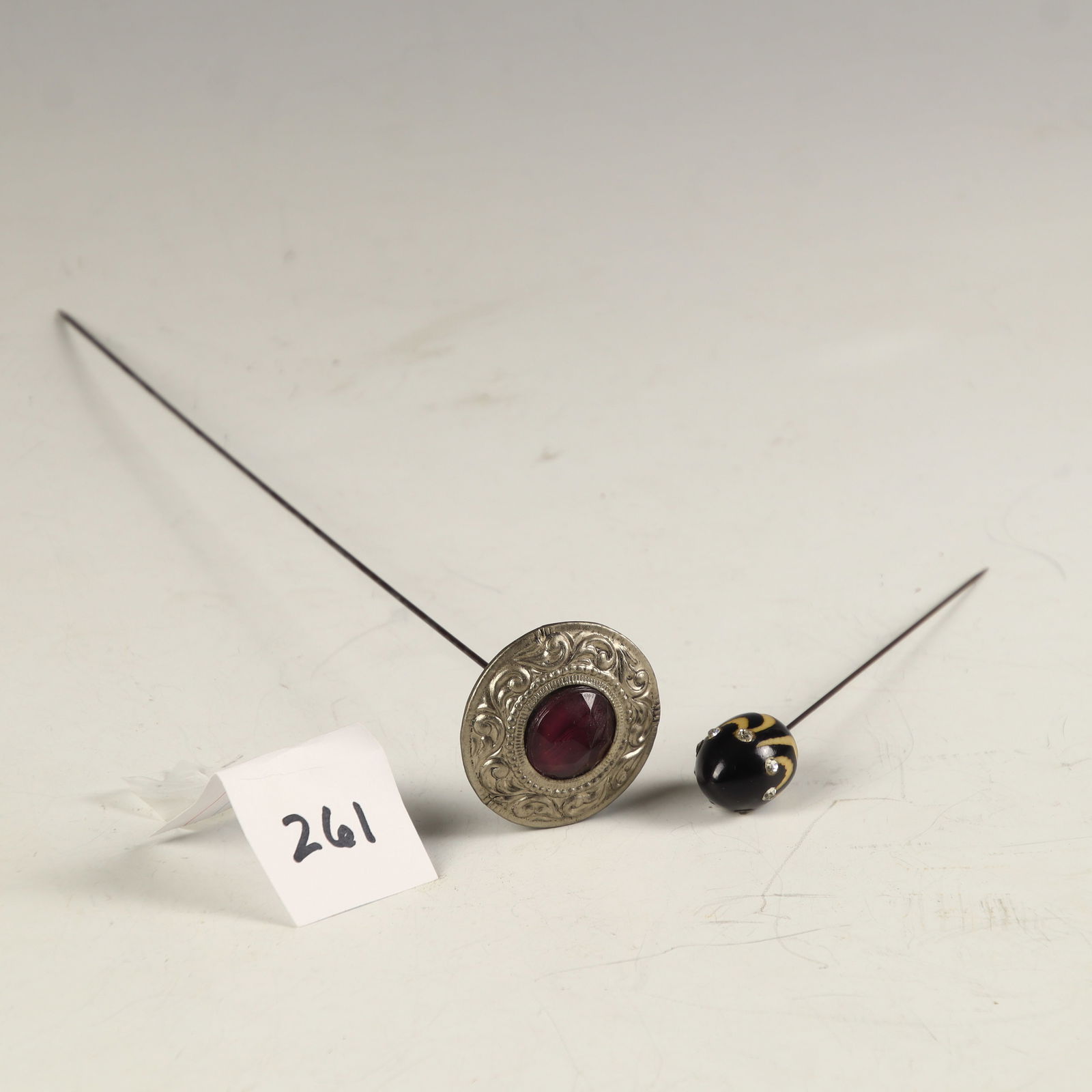 Two vintage stick pins: Two vintage stick pins, one has amethyst center 10 ¾ length and the other is wood and rhinestone 5 ¼ inches