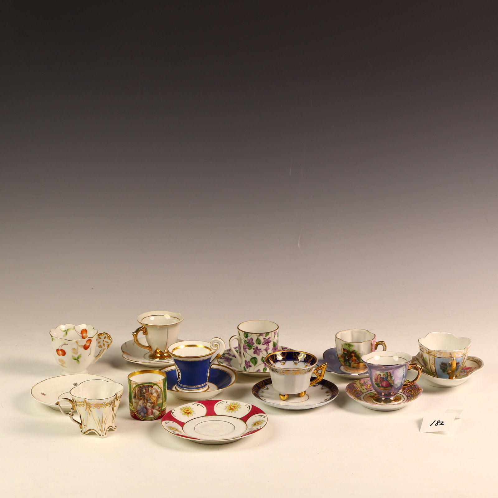 Lot of porcelain demitasse cups and saucers: Lot of porcelain demitasse cups and saucers