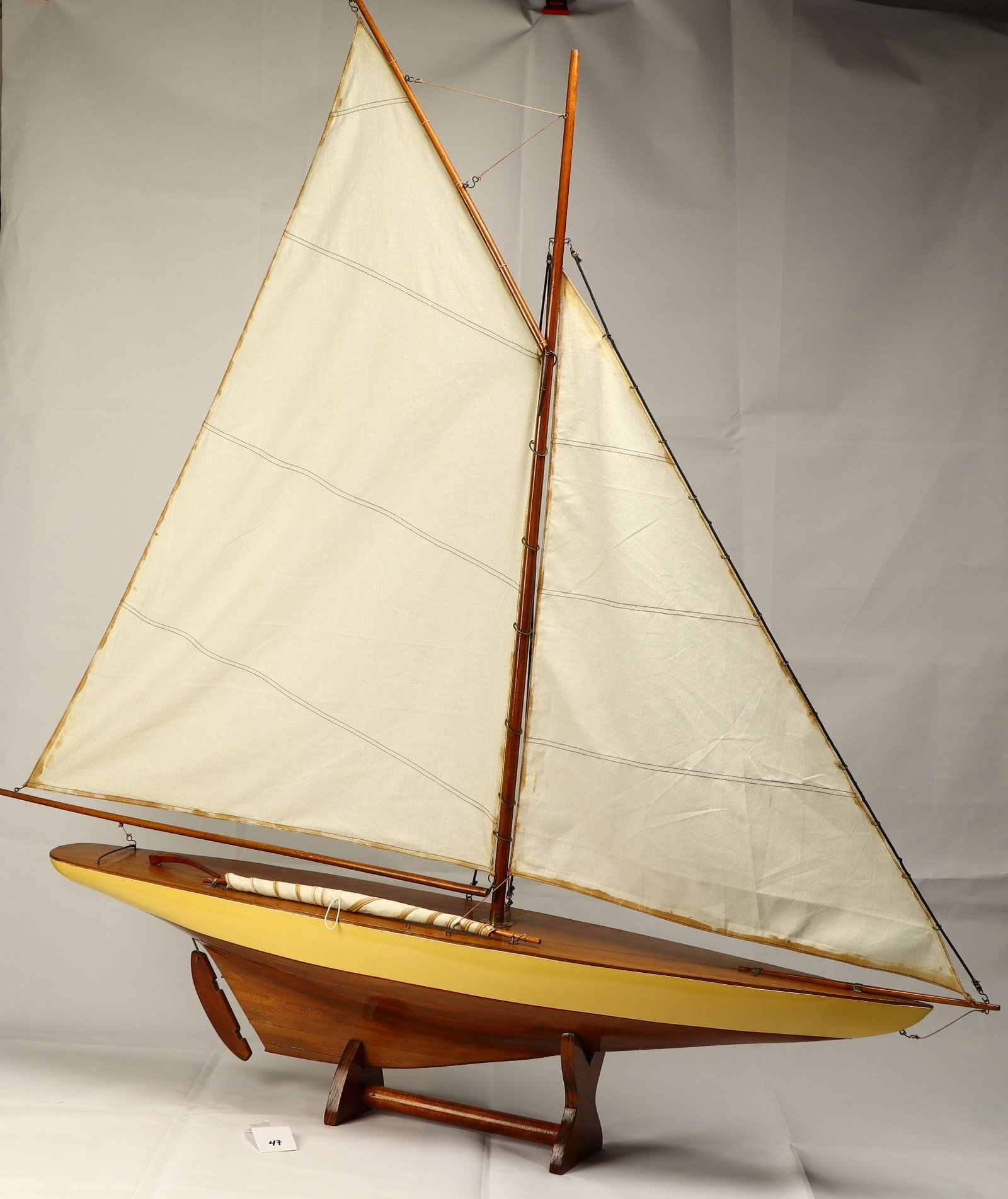Wooden sail boat skiff on stand with working rudder: Wooden sail boat skiff on stand with working rudder47L X 7W X 43 inches tall