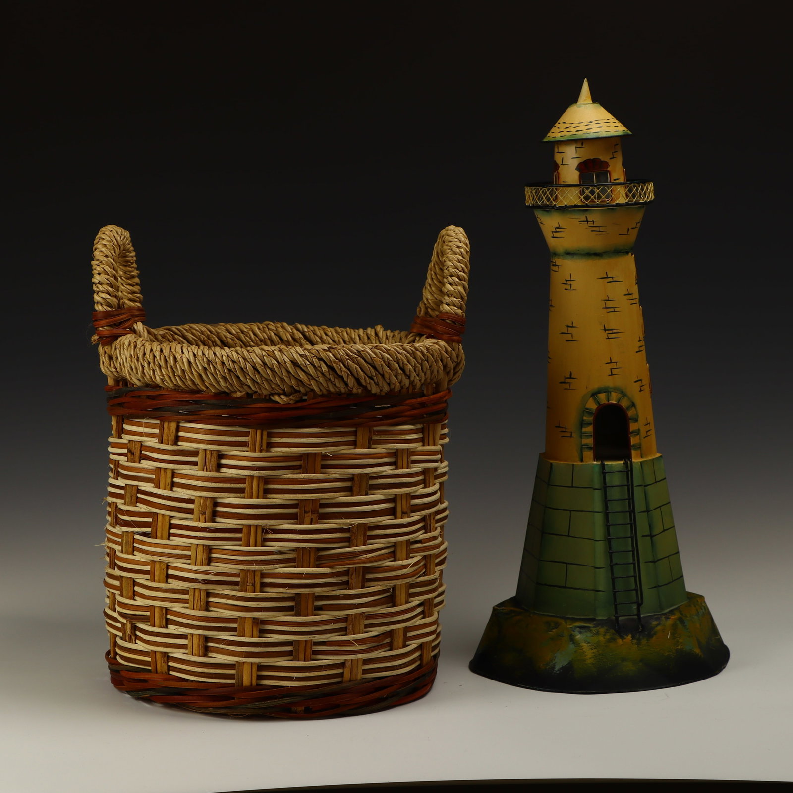 Tin lighthouse and a basket: Tin lighthouse 21 inches tall, 9.5 inches base diameter and a basket 12x12 inches with handles