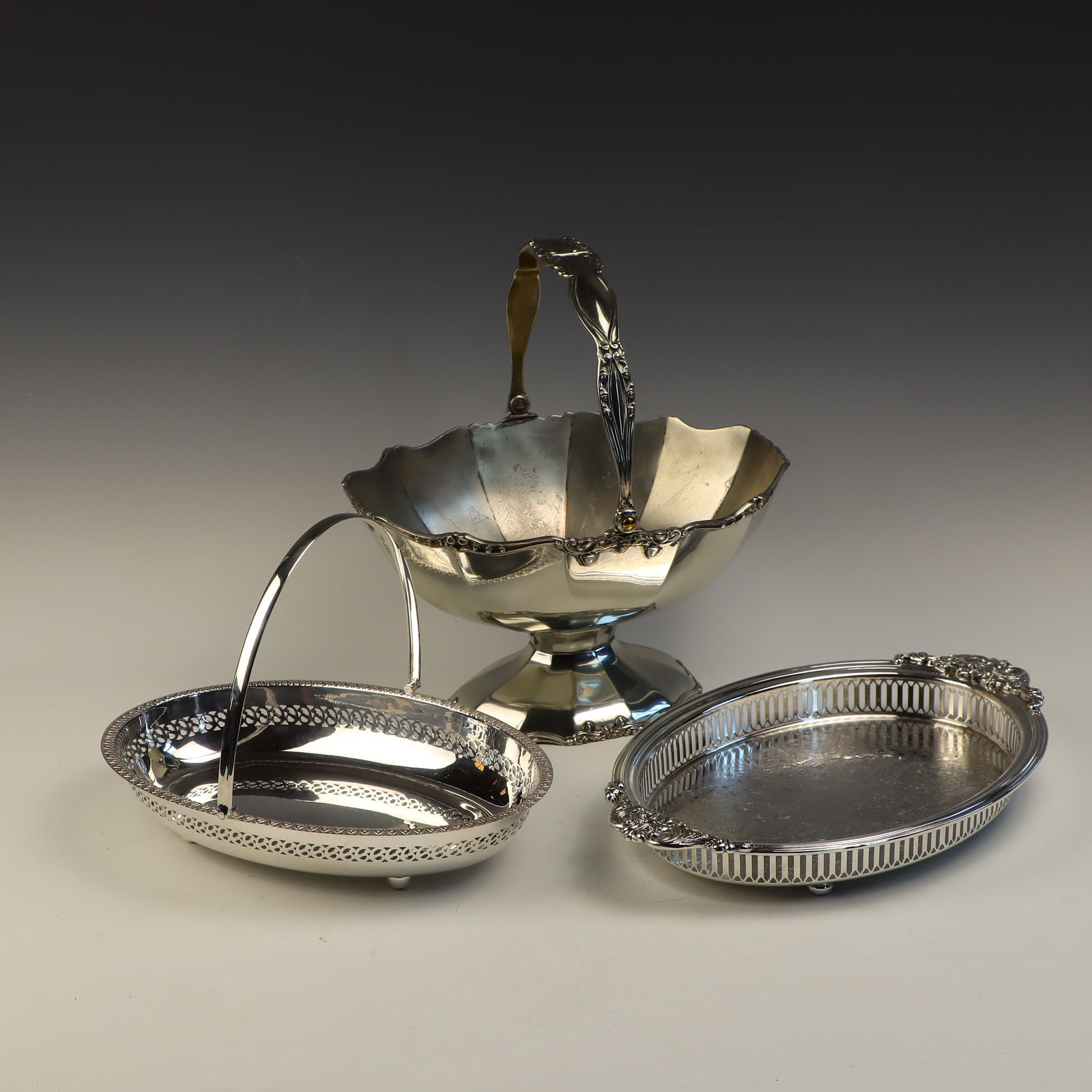 Lot of silver plate: Basket bowl is silver on copper 11X6.5X8.5 inches by IS Rogers Silver Co, basket tray 11X8 inches, reticulated tray is 13X9 inches