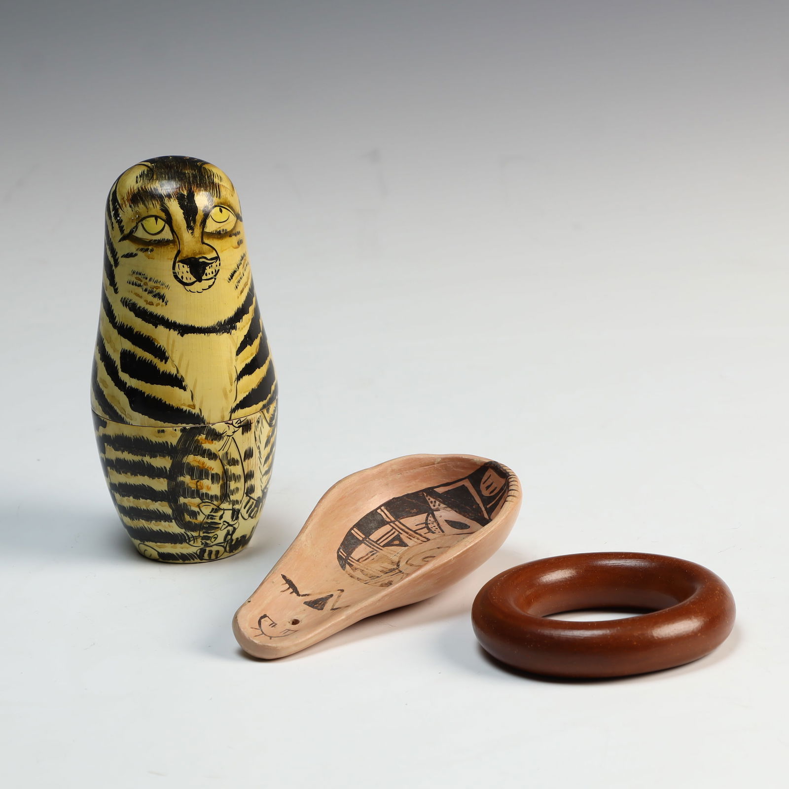African clay bangle, a stone spoon, and a wooden cat nesting dolls: African clay bangle, a stone spoon, and a wooden cat nesting dolls, tallest is 5.75 inches