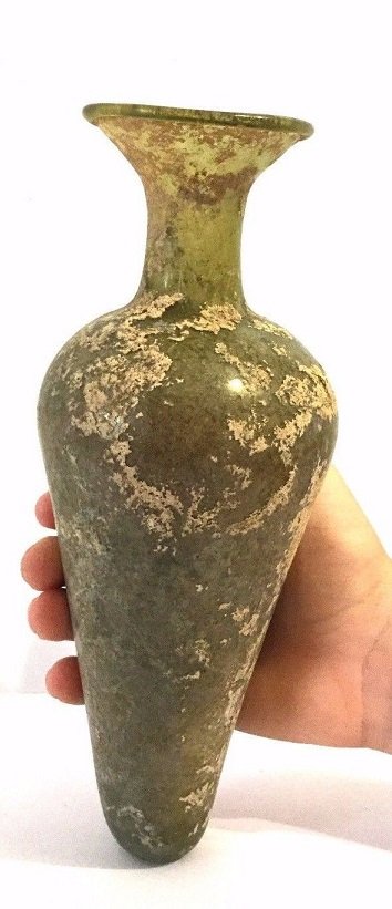 Large Roman glass tall flask Amphora .: Ancient Roman glass tall Amphora ,Circa 100AD-300AD, with a lovely iridescence patina , Intact. Provenance: Ex- Touma Dabbah Collection Size : 19 cm x 8 cm