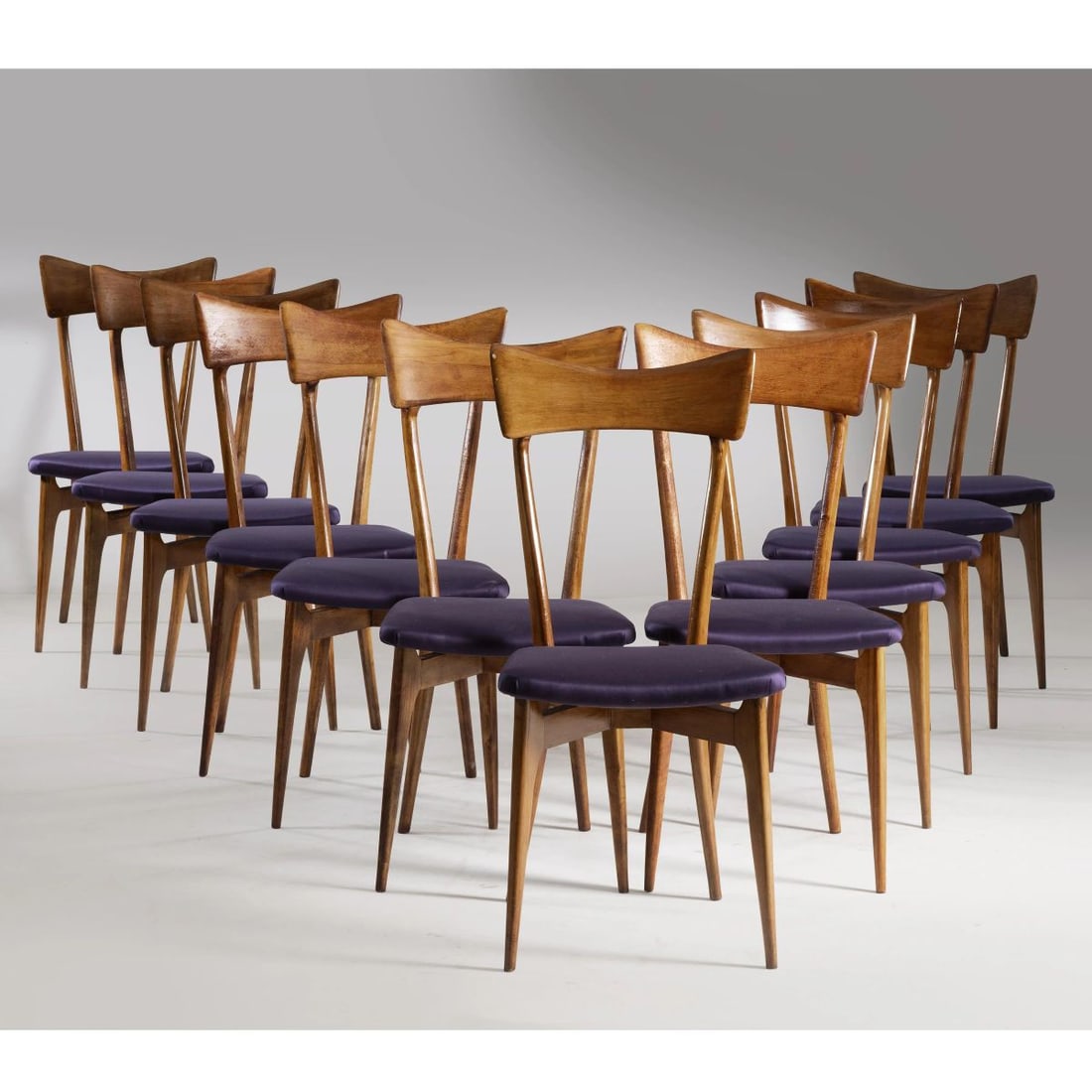 Ico Parisi: Ico Parisi (Palermo, 1916 - Como, 1996) TWELVE CHAIRS, WOODEN STRUCTURE, PURPLE FABRIC UPHOLSTERED DODICI SEDIE struttura in legno, imbottite e rivestite in tessuto nei toni del