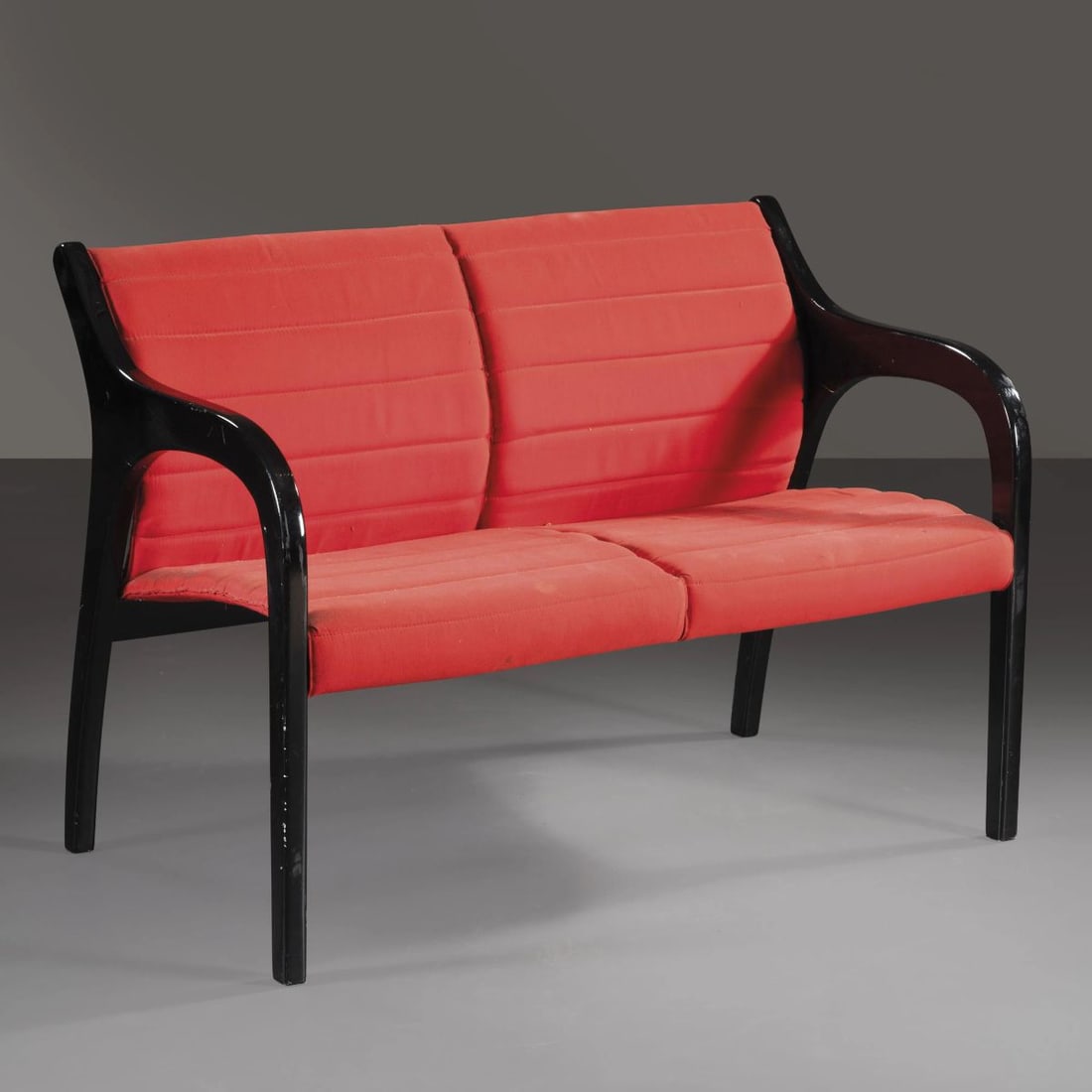 Claudio Salocchi: Claudio Salocchi (Milano, 1934 - 2012) A SOFA, BLACK LACQUERED WOODEN STRUCTURE, RED FABRIC UPHOLSTERED SEAT UN DIVANO in legno laccato nei toni del nero, seduta rivestita in pelle nei toni del rosso