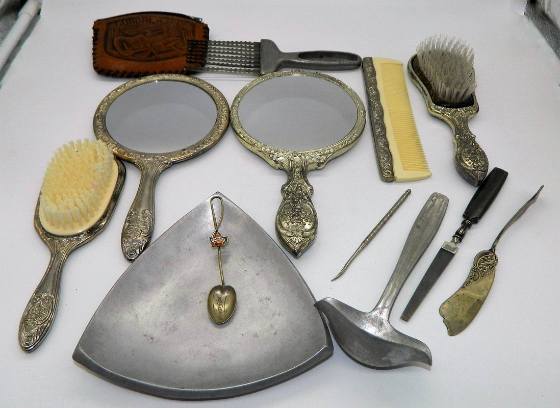 Lot of J Howard Quinn's Personal Belongings: This lot includes two vanity sets with two mirrors, two brushes, and one comb. Also includes a sterling silver knife, plated knife and spoon, and a few other miscellaneous items that belonged to Quinn