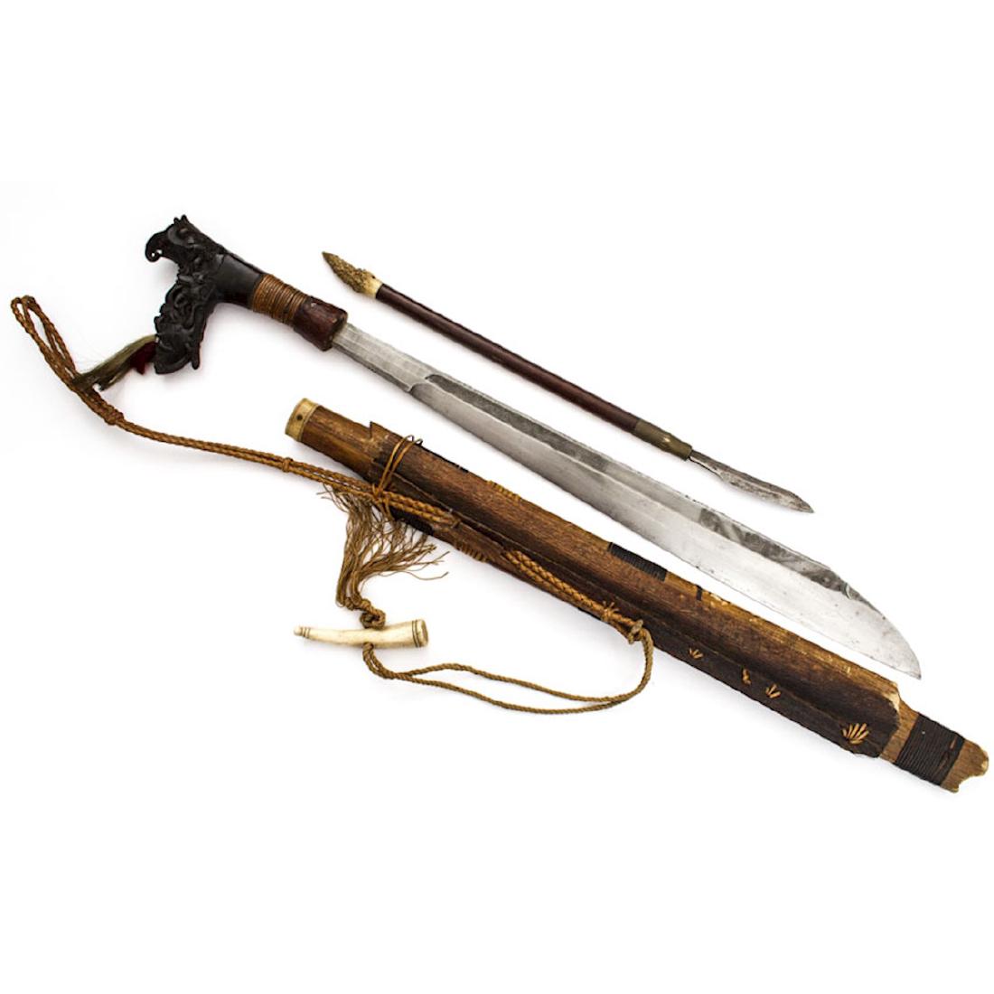 MANDAU SWORD, BORNEO, 19TH C.: Mandau is the traditional weapon of the Dayak people of Borneo, oftentimes associated with the headhunting ceremony. Strong blade with engraved design, well carved dark horn hilt nicely carved, atta