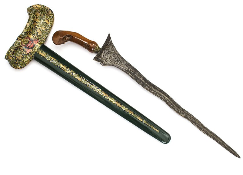 KRIS DAGGER, JAVA, 19 C.: Fine old blade (pamor restored) and Surakarta style hilt, with green and gold demon face and fanciful Indonesian designs. It is noted by Edward Frey in the description for this kris that it is "Anothe
