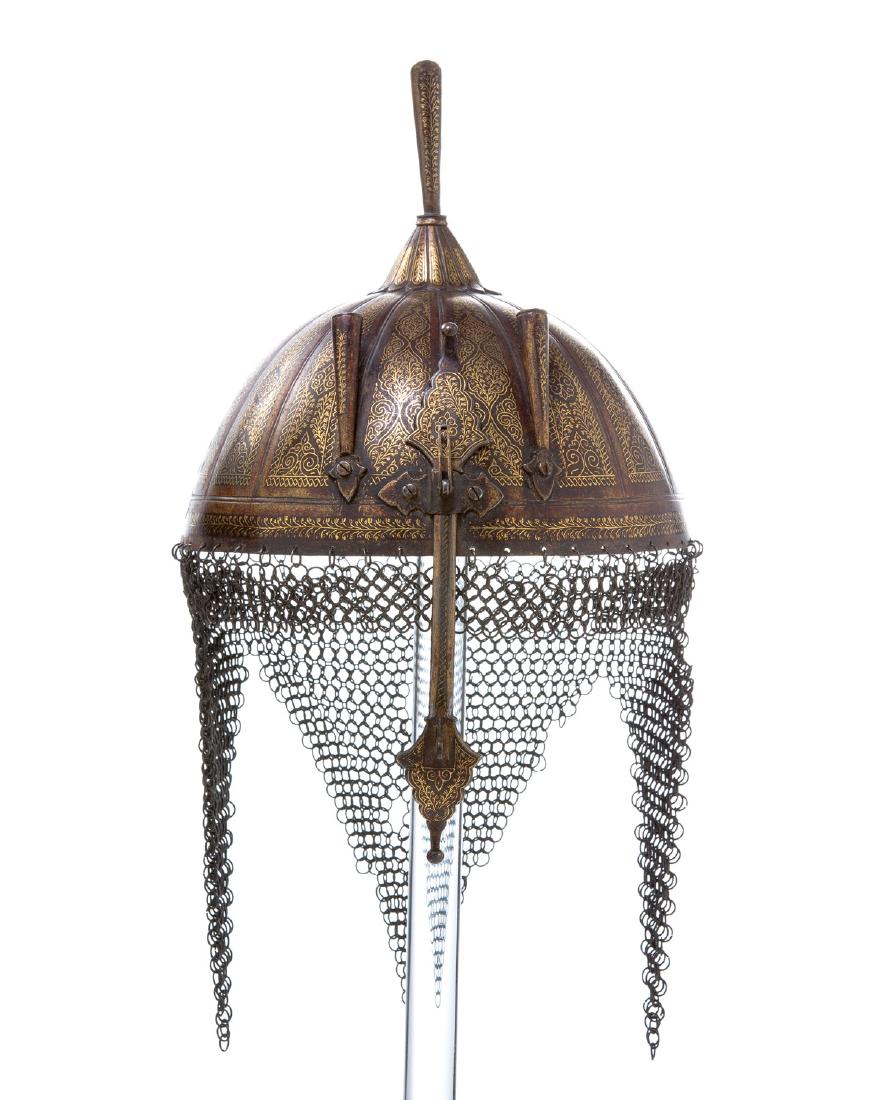 KHULA Â KHUD HELMET WITH GOLD KOFTGARI: Beautiful fluted steel bowl covered with fine koftgari gold work, iron link chain mail is intact, plume holder and nose guard. 15 in. including chain mail